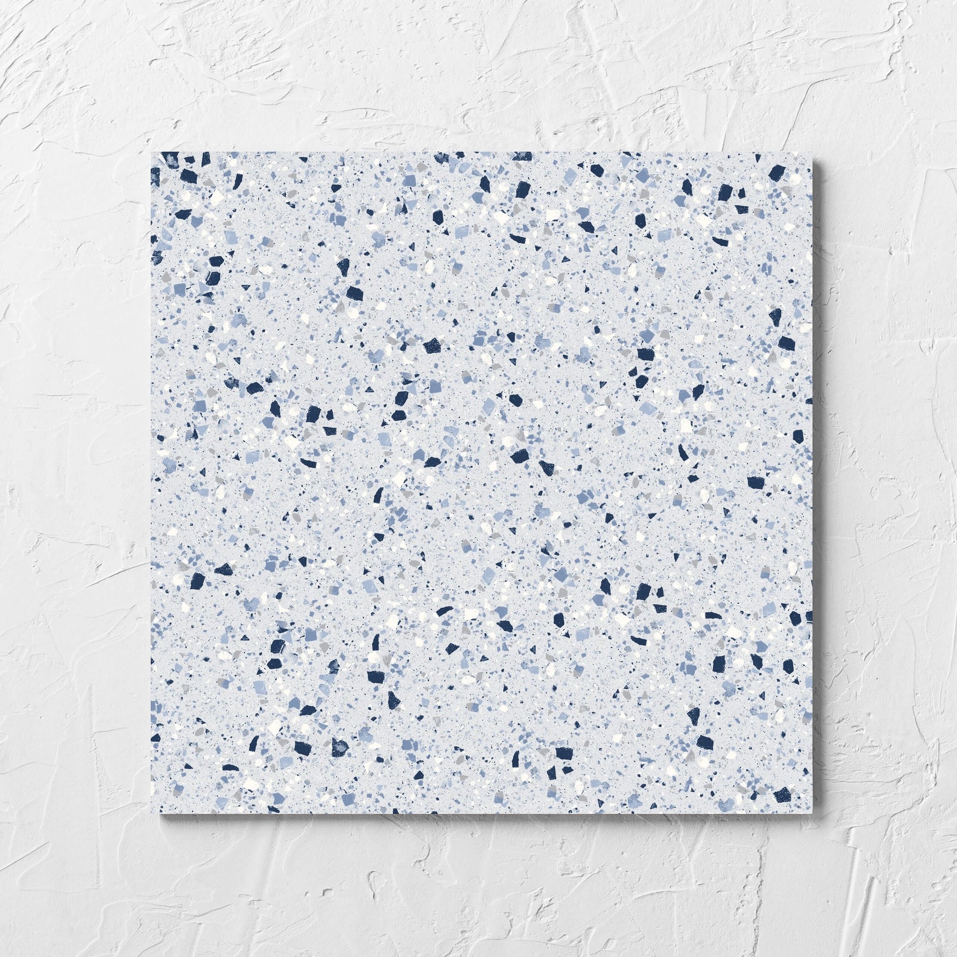 C Venice 300x300 Matt Blue Terrazzo Look Rectified tile laid flat on a white rendered wall, showing the blue terrazzo look surface