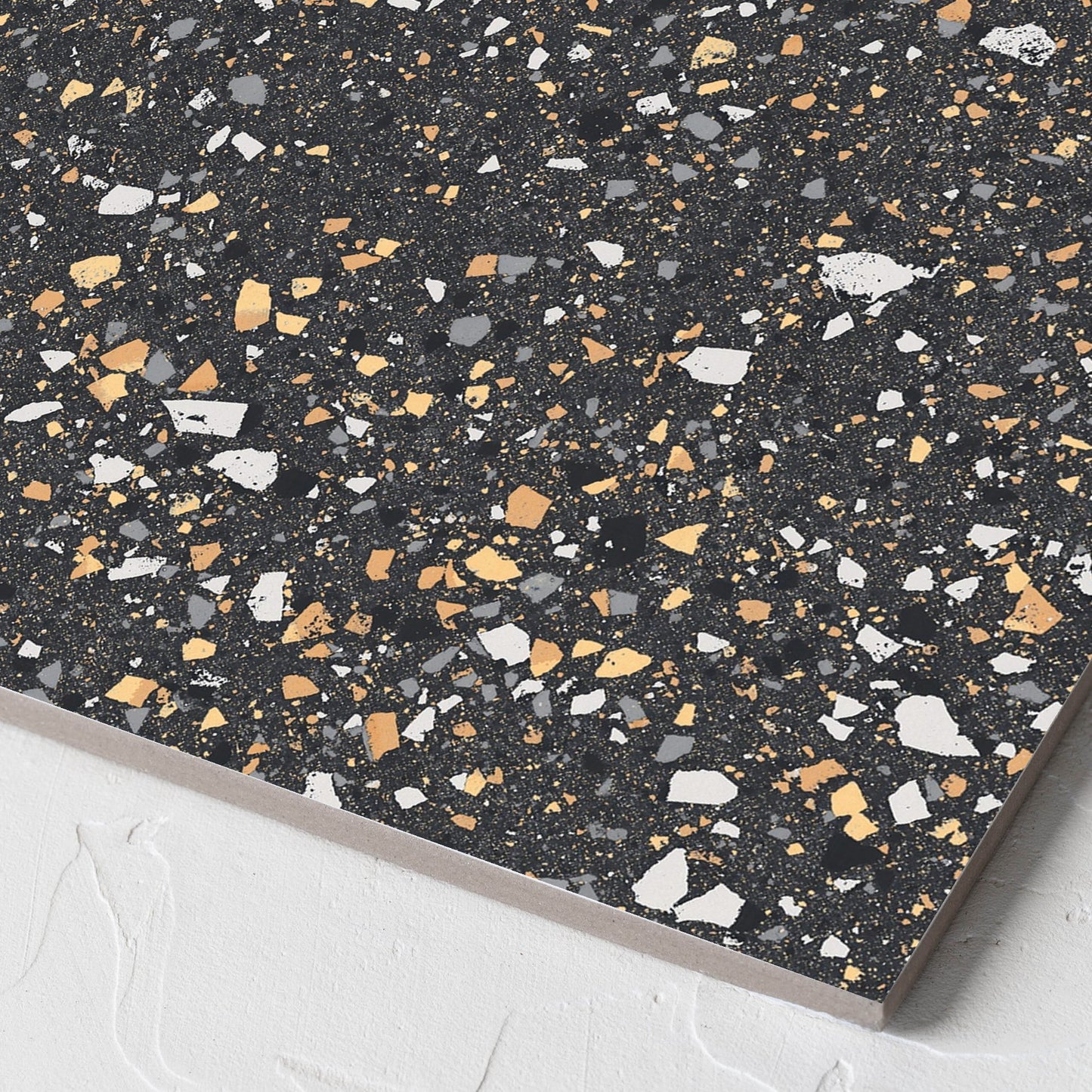 Corner close-up of the C Venice 300x300 Matt Graphite Terrazzo Look Rectified tile showing the terrazzo look tiles surface and the edge profile
