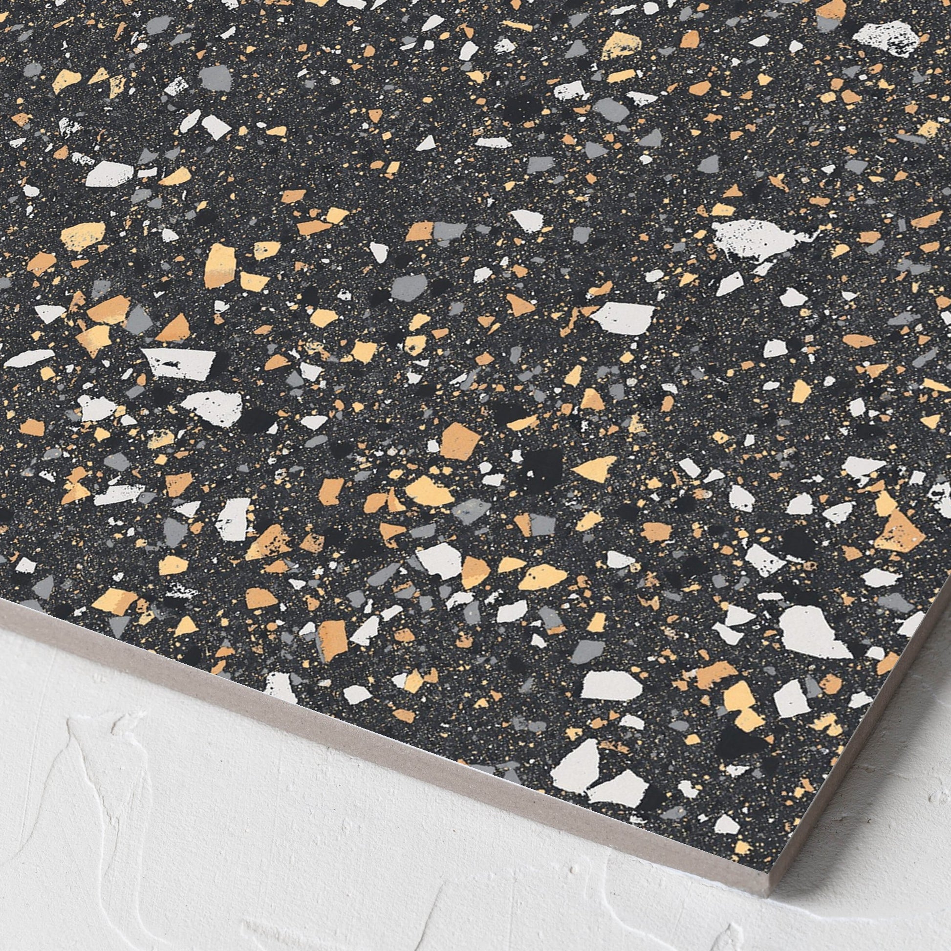 Corner close-up of the C Venice 300x300 Matt Graphite Terrazzo Look Rectified tile showing the terrazzo look tiles surface and the edge profile