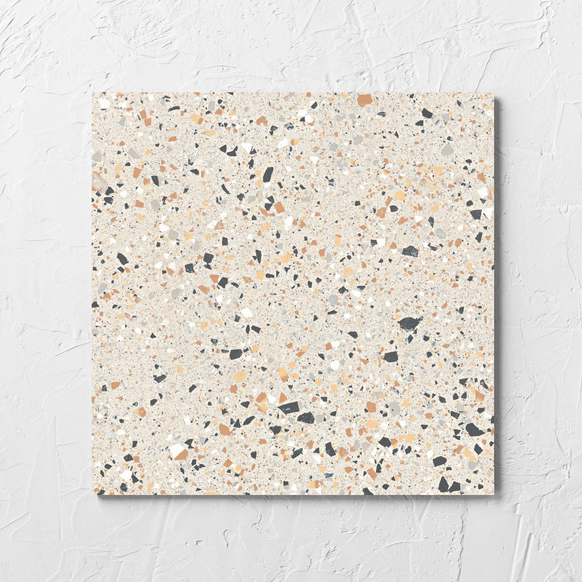 C Venice 300x300 Matt Ivory Terrazzo Look Rectified tile laid flat on a white rendered wall, showing the tile surface