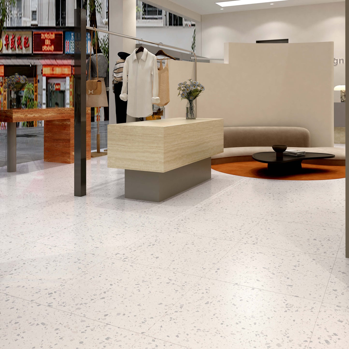 C Venice 300x300 Matt Zinc Terrazzo Look Rectified tiles installed as a polished white terrazzo-effect floor in a modern fashion boutique with clothing racks and curved sofa.
