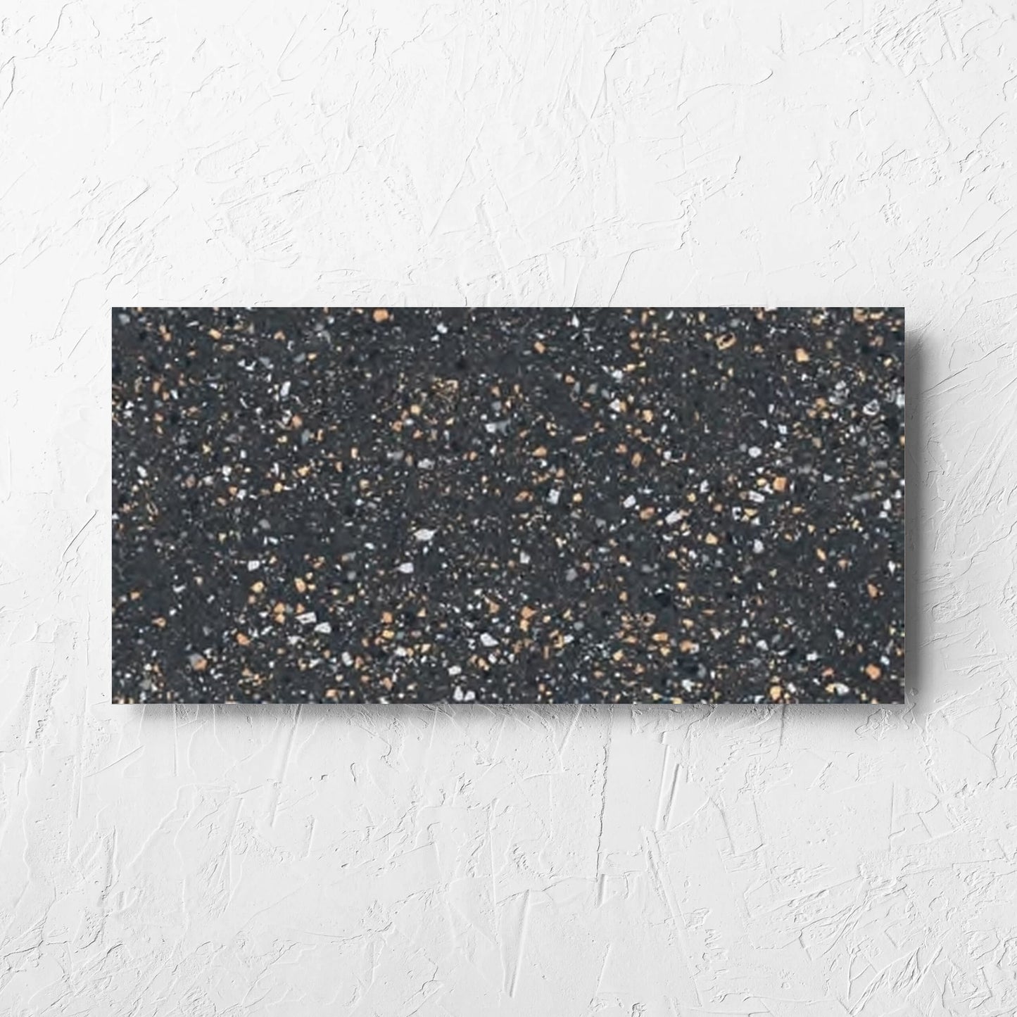 C Venice 300x600 Matt Graphite Terrazzo Look Rectified tile laid flat on a white rendered wall, showing the tile surface
