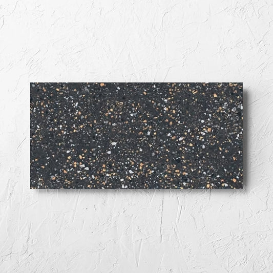 C Venice 300x600 Matt Graphite Terrazzo Look Rectified tile laid flat on a white rendered wall, showing the tile surface