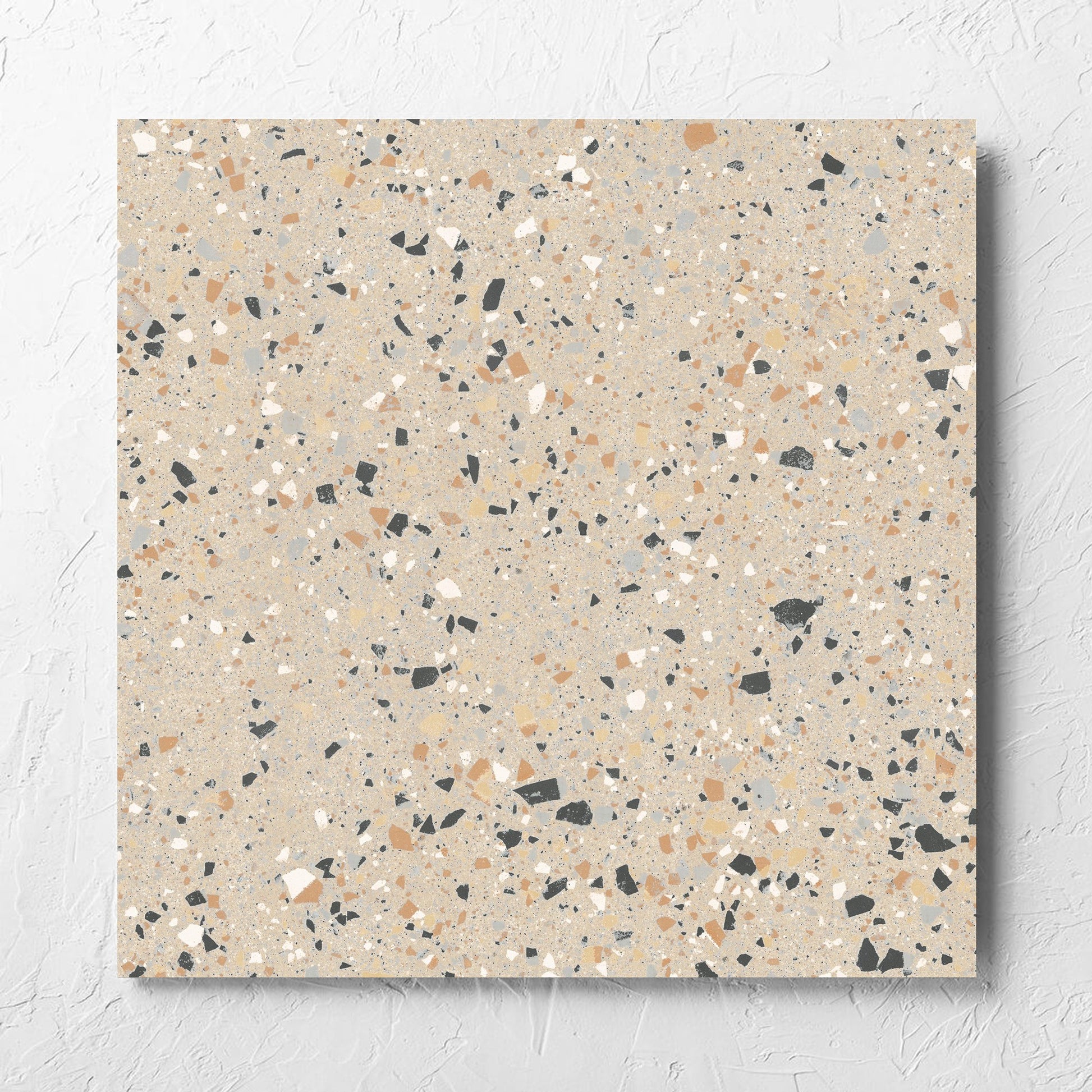 C Venice 600x600 Matt Beige Terrazzo Look Rectified tile laid flat on a white rendered wall, showing the tile surface