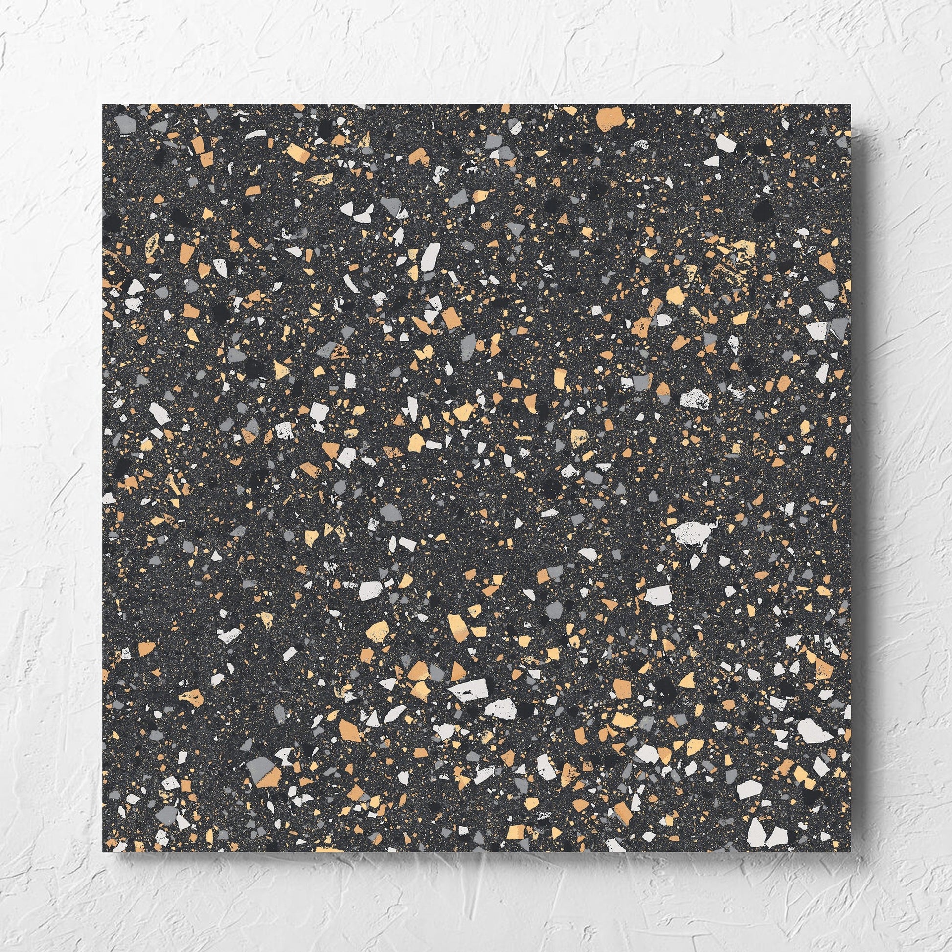 C Venice 600x600 Matt Graphite Terrazzo Look Rectified tile laid flat on a white rendered wall, showing the tile surface