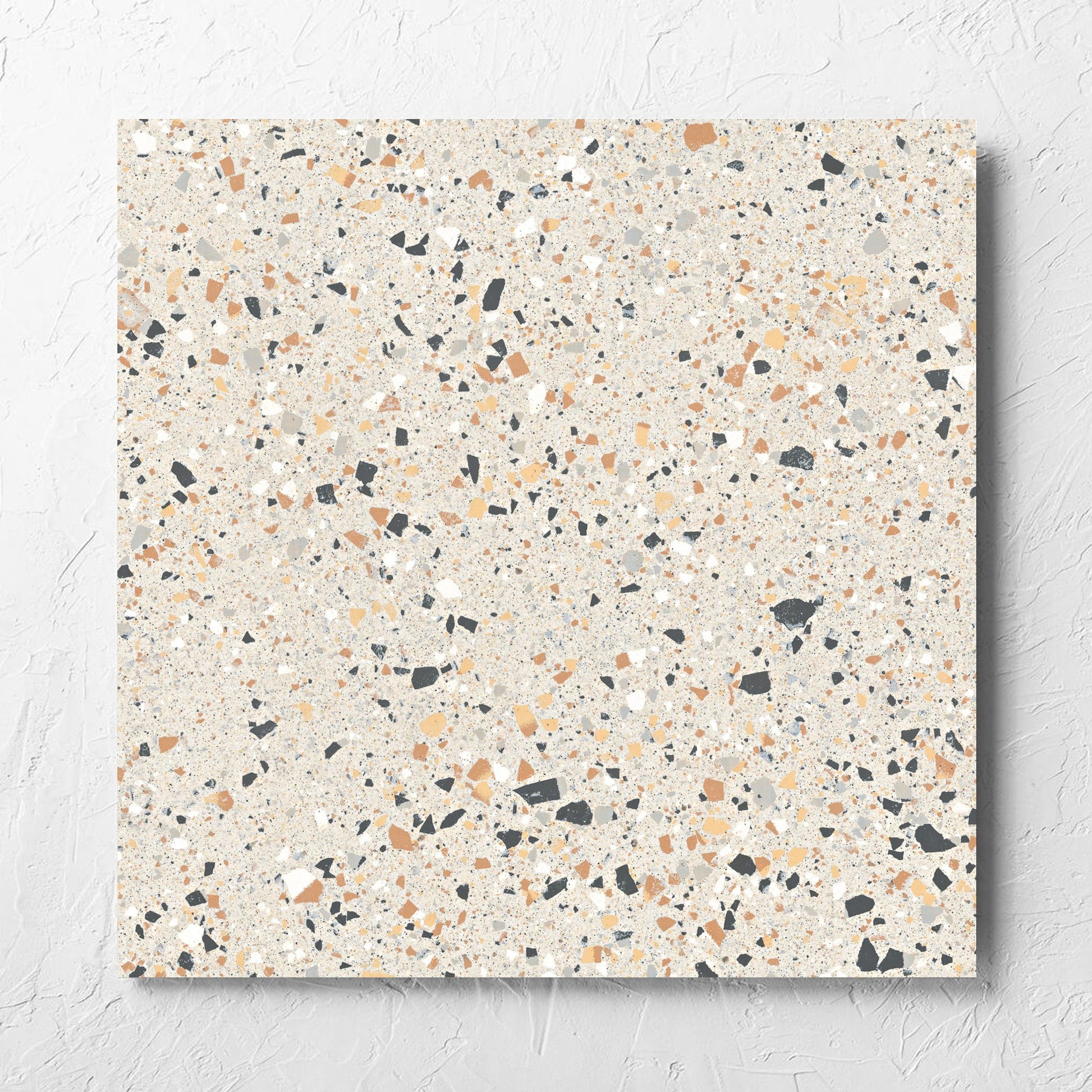 C Venice 600x600 Matt Ivory Terrazzo Look Rectified tile laid flat on a white rendered wall, showing the tile surface