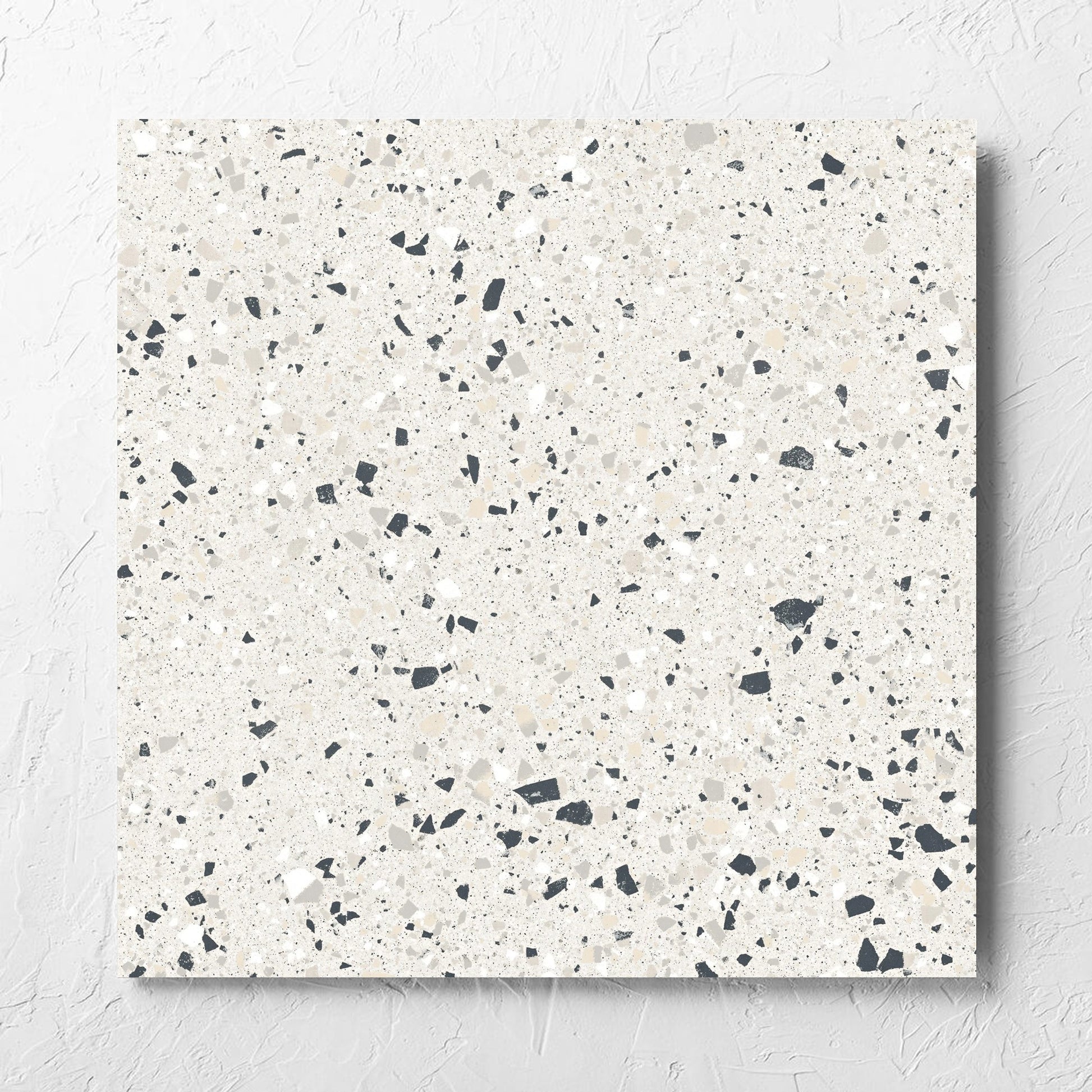 C Venice 600x600 Matt Silver Terrazzo Look Rectified tile laid flat on a white rendered wall, showing the tile surface