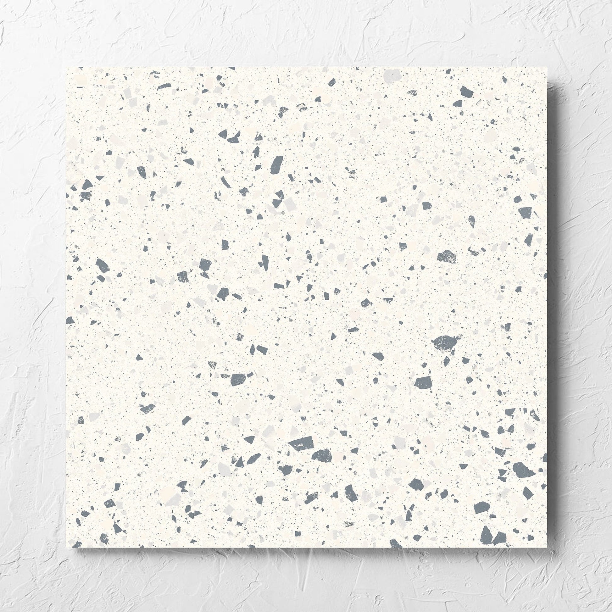 C Venice 600x600 Matt White Terrazzo Look Rectified tile laid flat on a white rendered wall, showing the tile surface