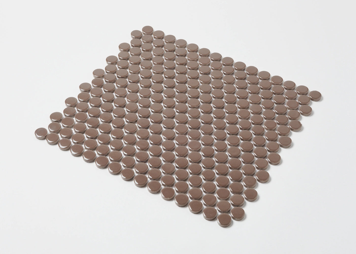 Pack shot of Cappuccino Gloss Diameter Glazed Porcelain Penny Round 19mm tiles arranged in a flat grid, showing warm brown gloss circular mosaic pieces.
