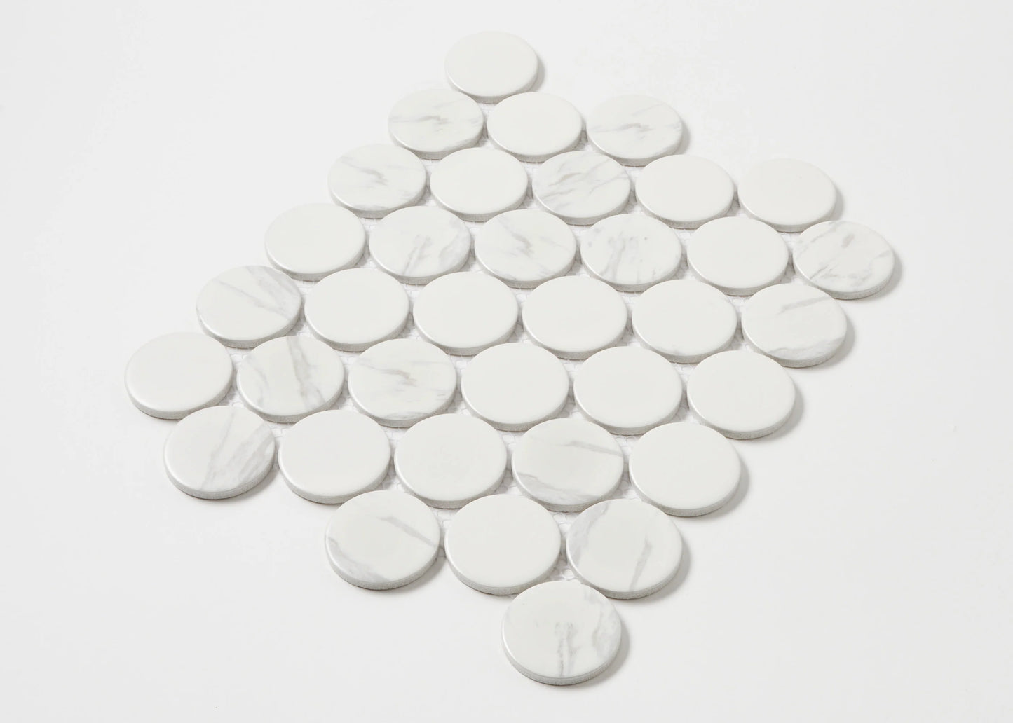 Carrara Look Matte Porcelain Glazed Penny Round 48mm tiles arranged in a diamond-shaped mosaic sheet, showing white glazed circular tiles with subtle grey marble veining.