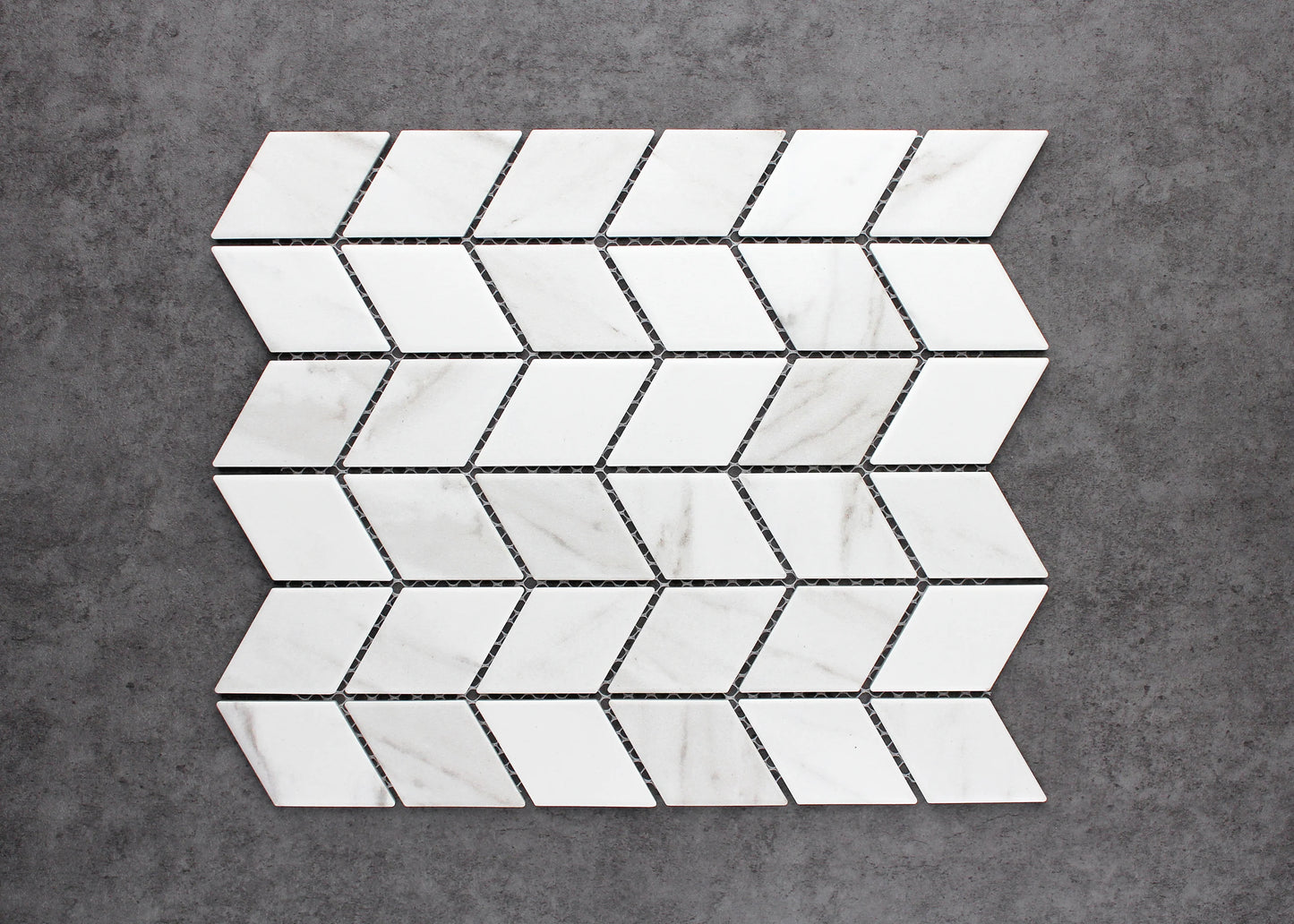 Pack shot of Carrara Look Matte Porcelain Glazed Rhombus 48x48mm tiles arranged in a chevron mosaic sheet pattern with white marble-look finish and grey veining.