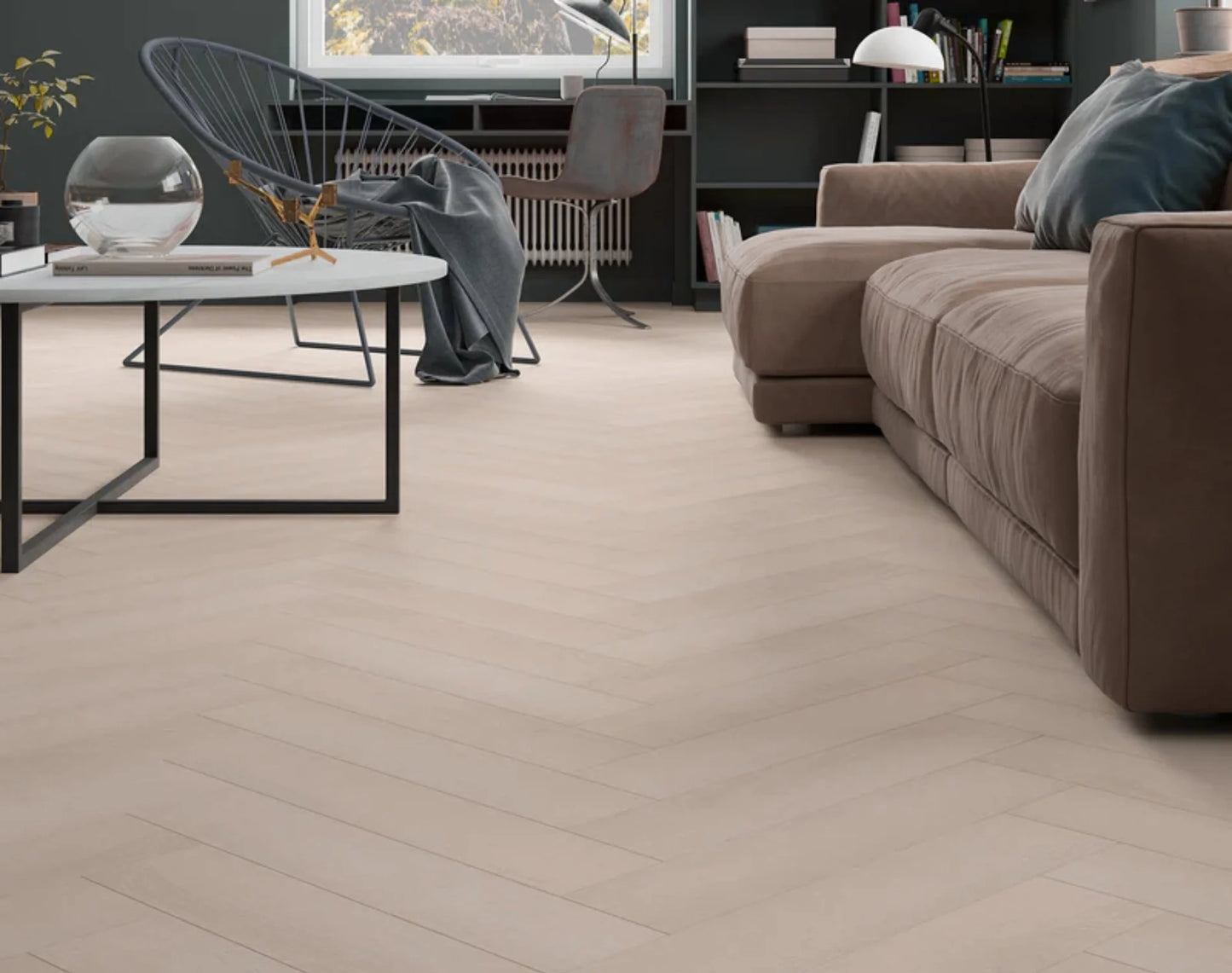 Casper White iDesign Herringbone Flooring 15/3mm installed in a modern living room with a brown sofa and dark feature walls.