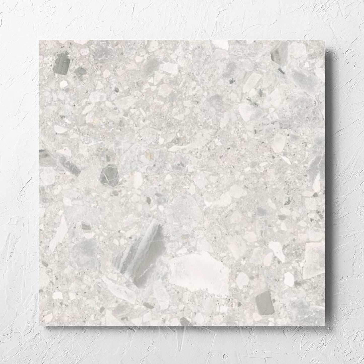 Ceppo Bianco External 600x600mm tile laid flat on a white rendered wall, showing the bianco matt surface