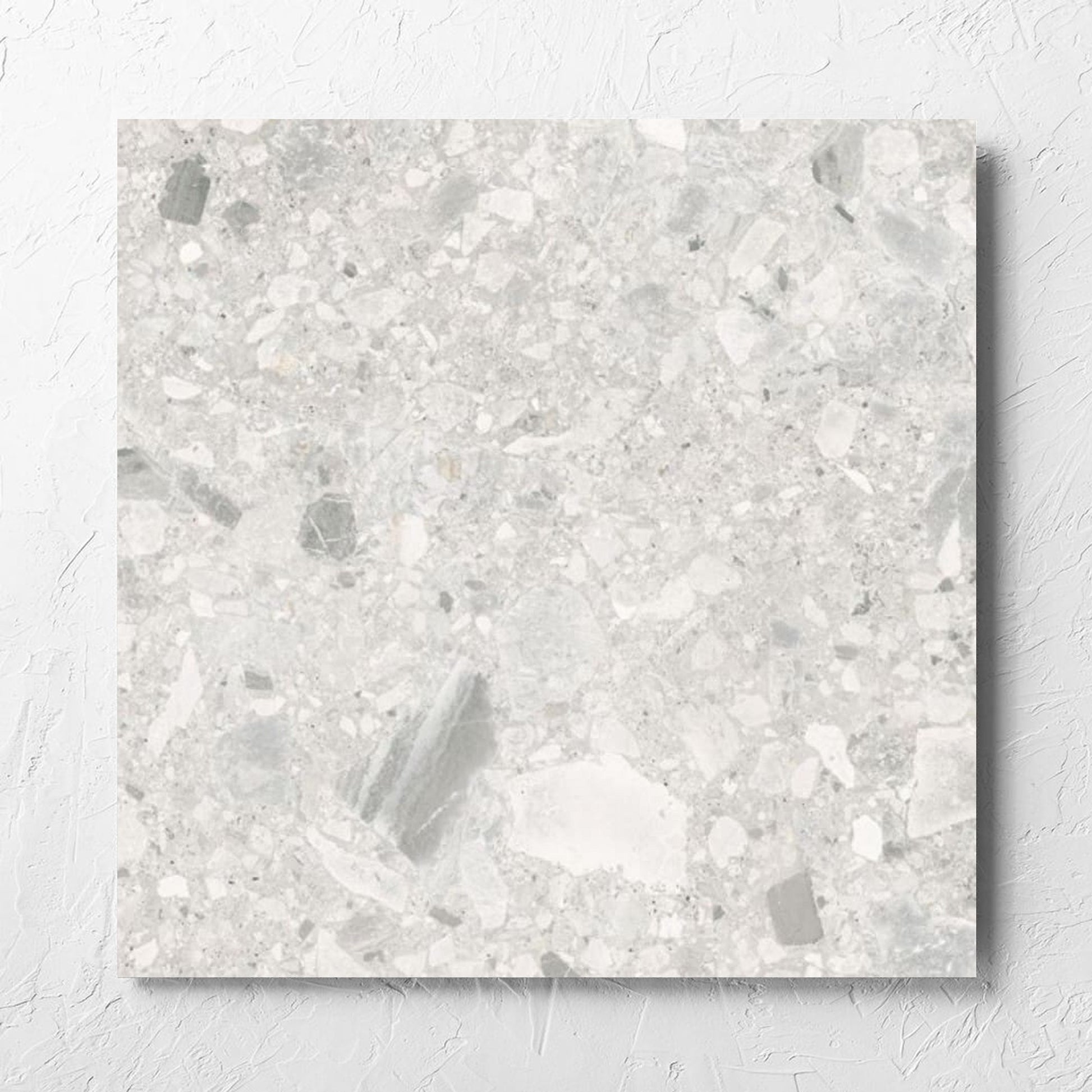 Ceppo Bianco External 600x600mm tile laid flat on a white rendered wall, showing the bianco matt surface