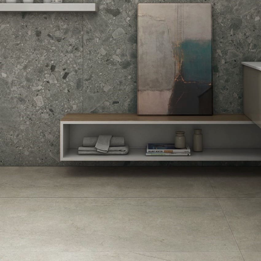 Ceppo Grey InOut 300x600mm terrazzo-effect grey wall tiles installed in a modern bathroom with a floating timber-top shelf and abstract artwork.