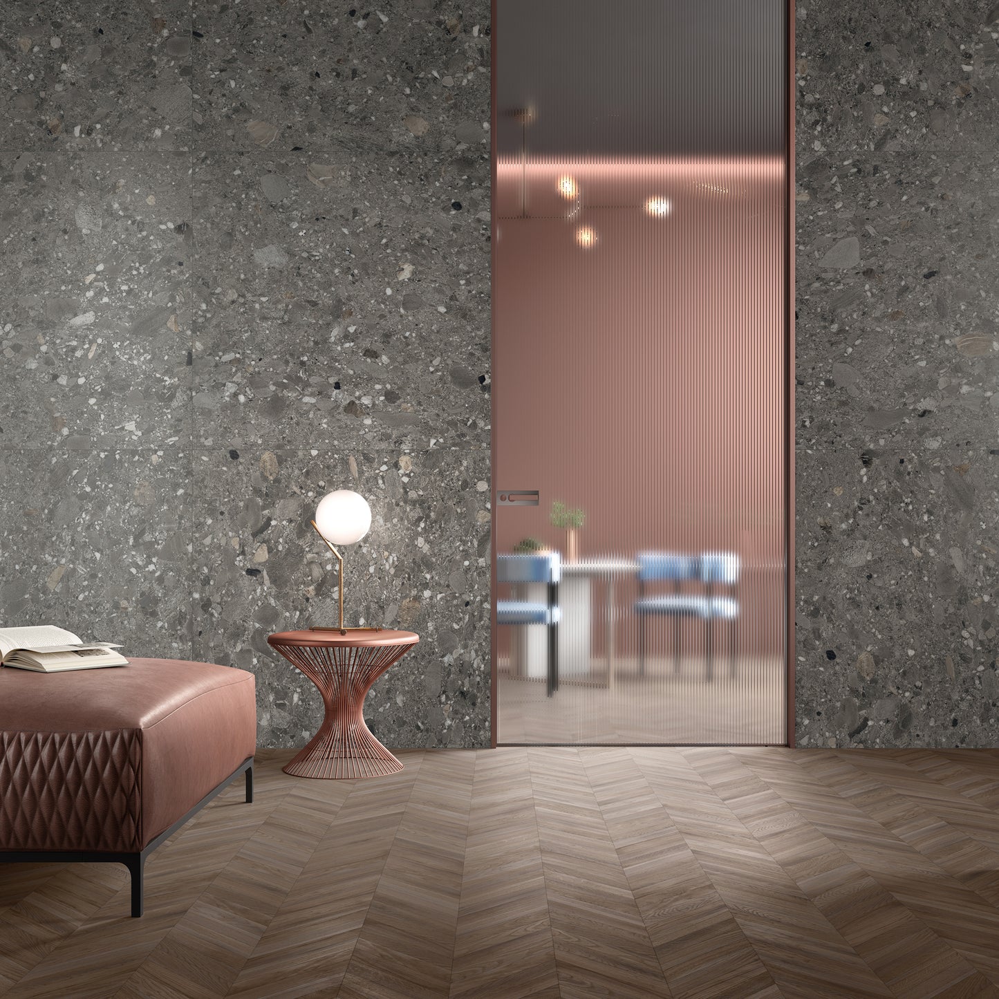 Ceppo Grey InOut 600x600mm porcelain tile installed as a dramatic feature wall in a contemporary lounge with herringbone timber floor, fluted glass door, and rose-gold side table.