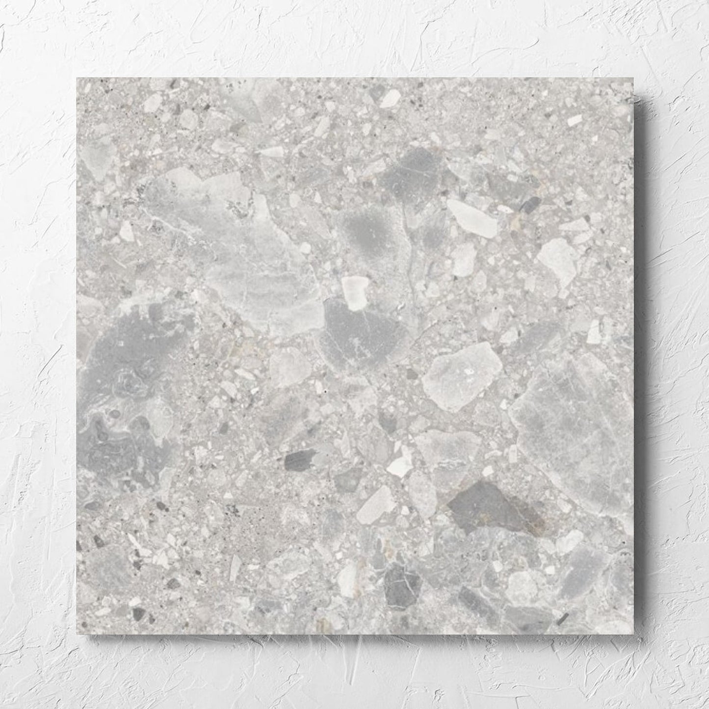 Ceppo Stone InOut 600x600mm tile laid flat on a white rendered wall, showing the tile surface
