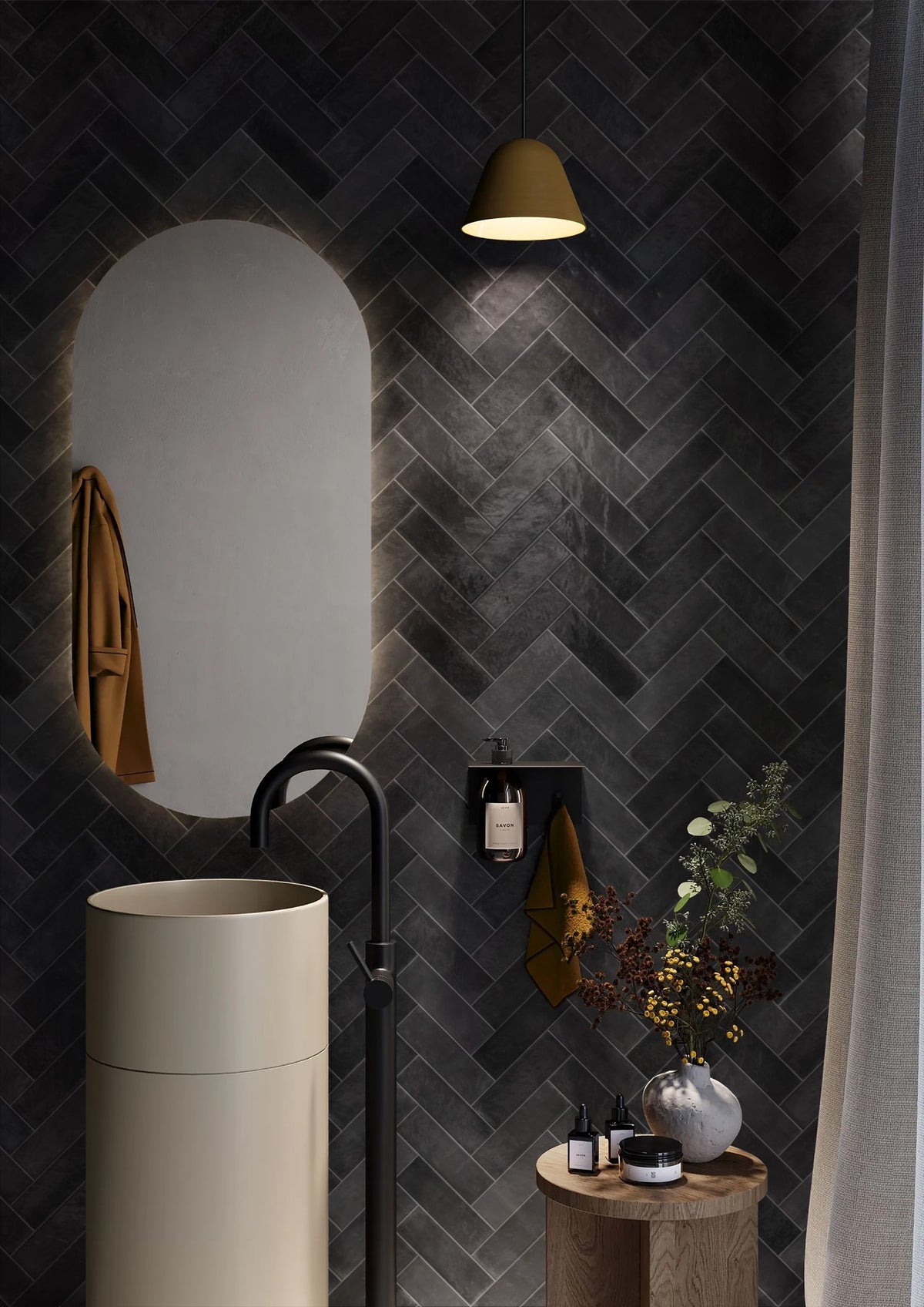Chroma Black Matt 52x160mm tiles laid in a herringbone pattern on a dramatic bathroom feature wall, styled with a cream freestanding basin and brass pendant light.