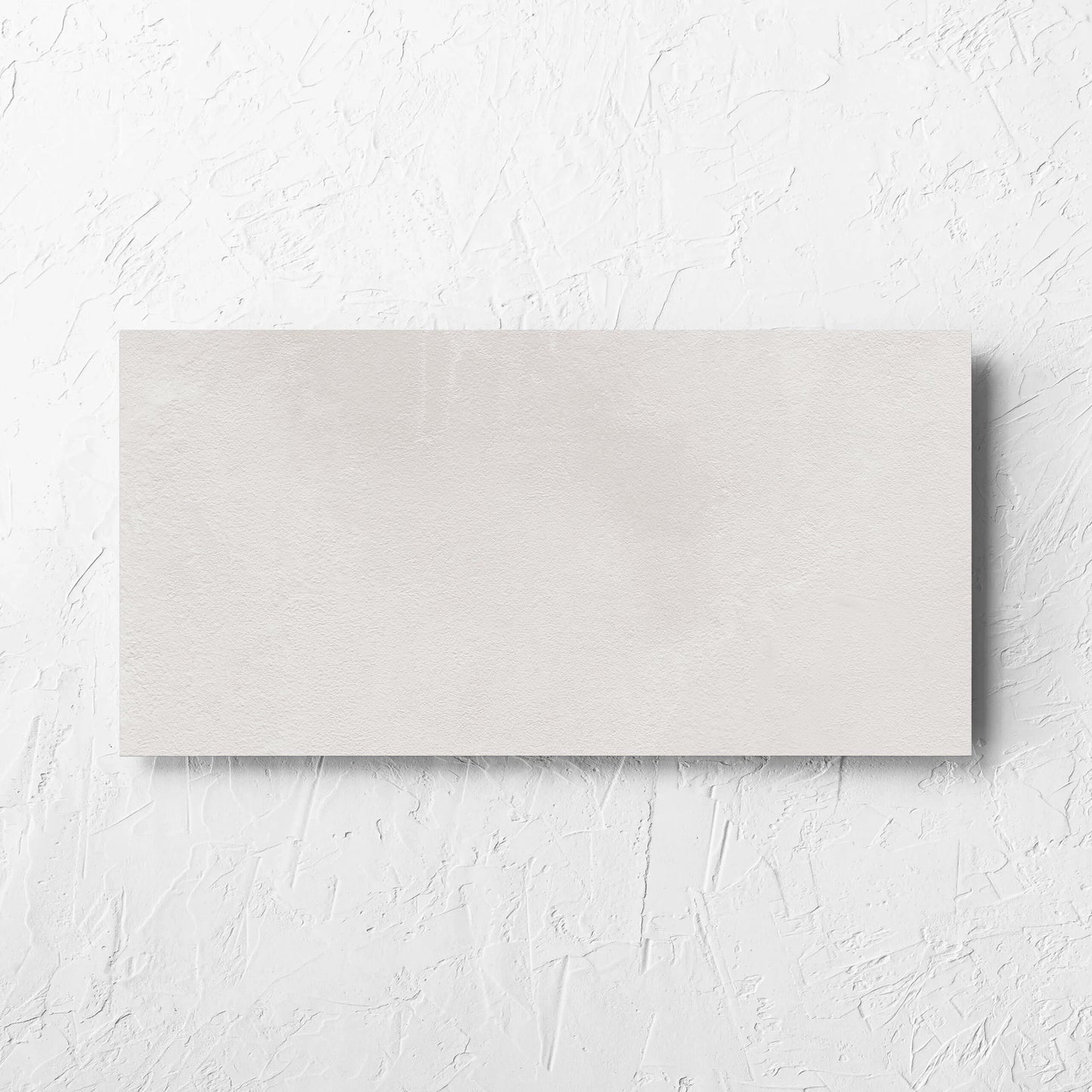 Clay Bari White 300x600mm tile laid flat on a white rendered wall, showing the matt surface