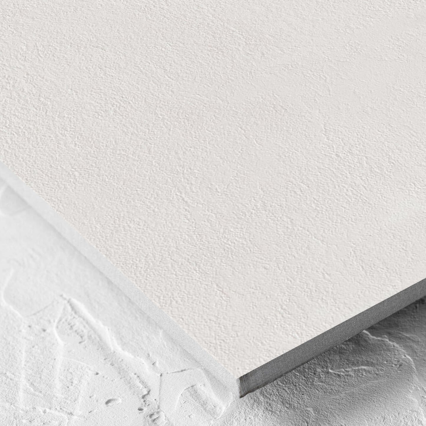 Corner close-up of the Clay Bari White 600x600mm tile showing the matt surface and the edge profile