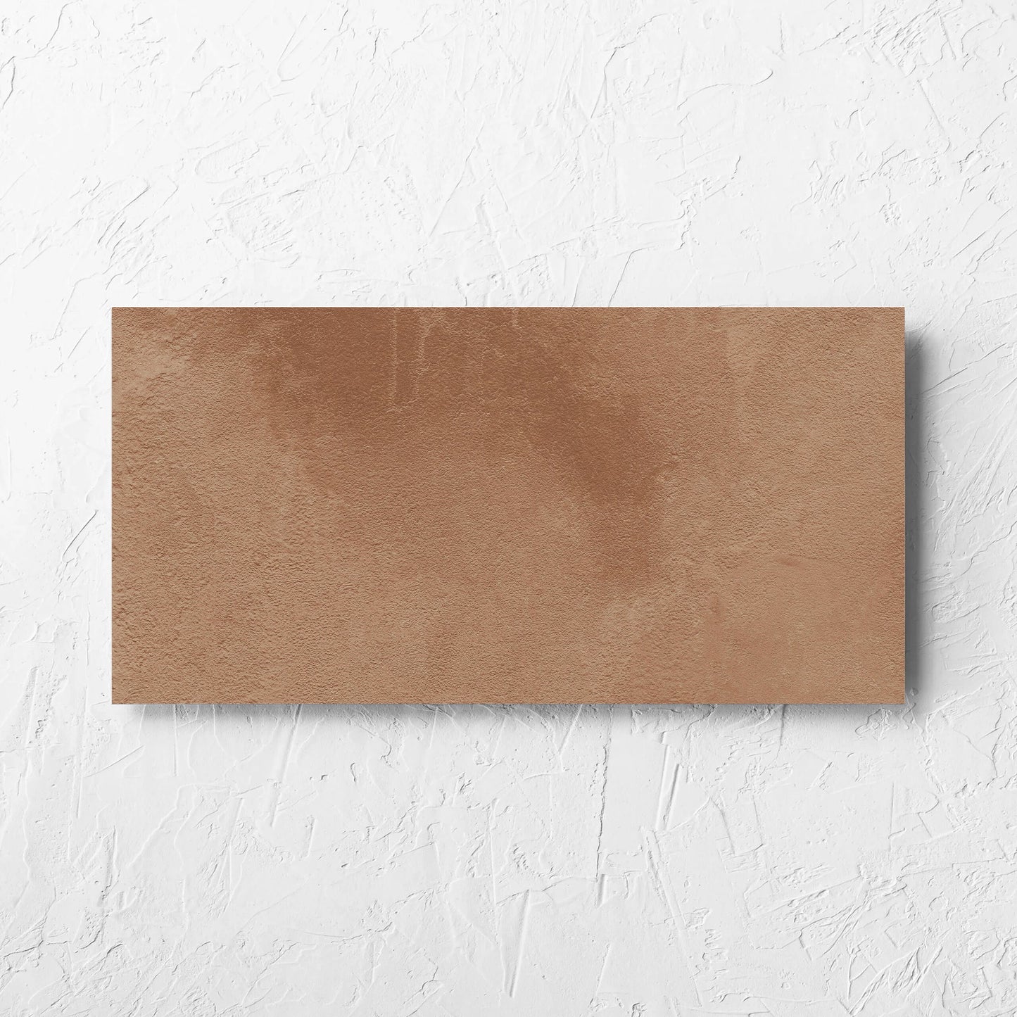 Clay Firenze Dark Terracotta 300x600mm tile laid flat on a white rendered wall, showing the matt surface