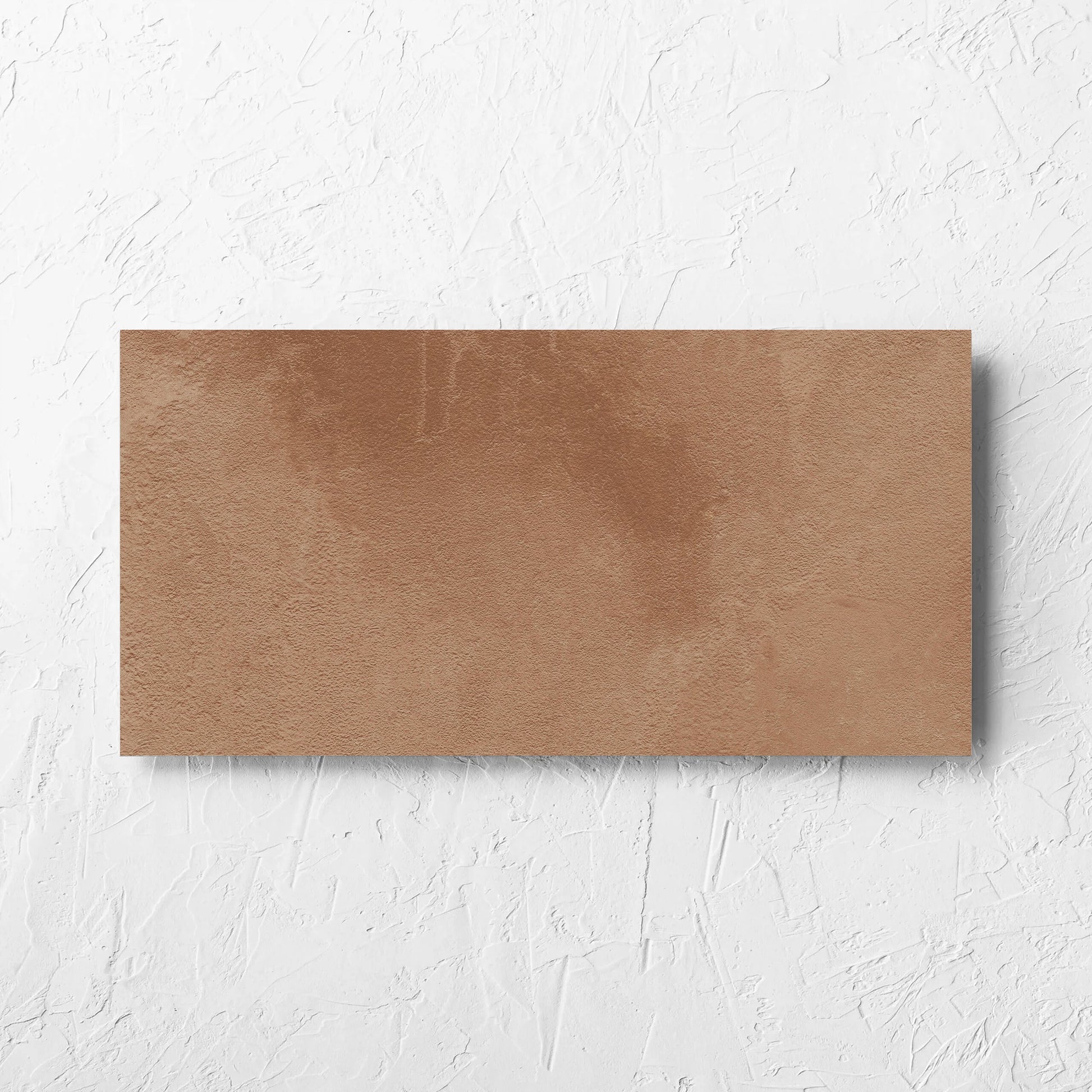 Clay Firenze Dark Terracotta 300x600mm tile laid flat on a white rendered wall, showing the matt surface