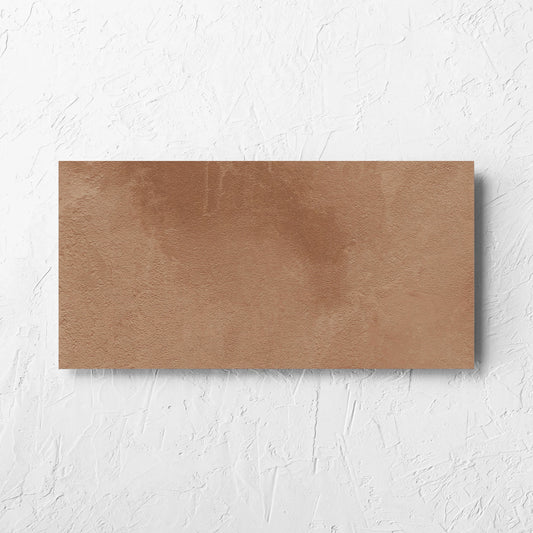 Clay Firenze Dark Terracotta 300x600mm tile laid flat on a white rendered wall, showing the matt surface