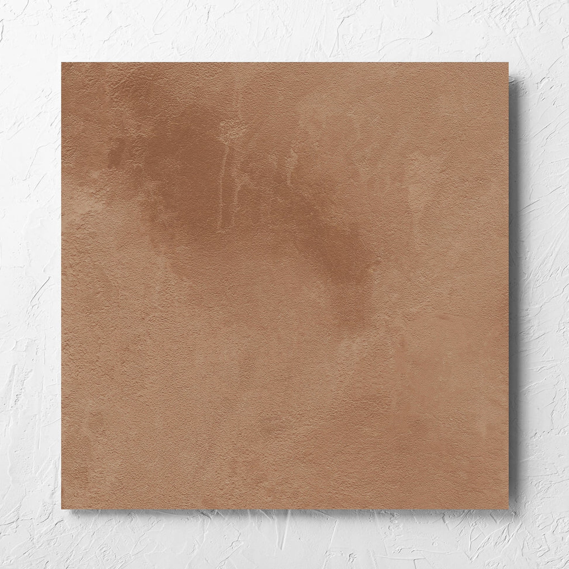 Clay Firenze Dark Terracotta 600x600mm tile laid flat on a white rendered wall, showing the matt surface