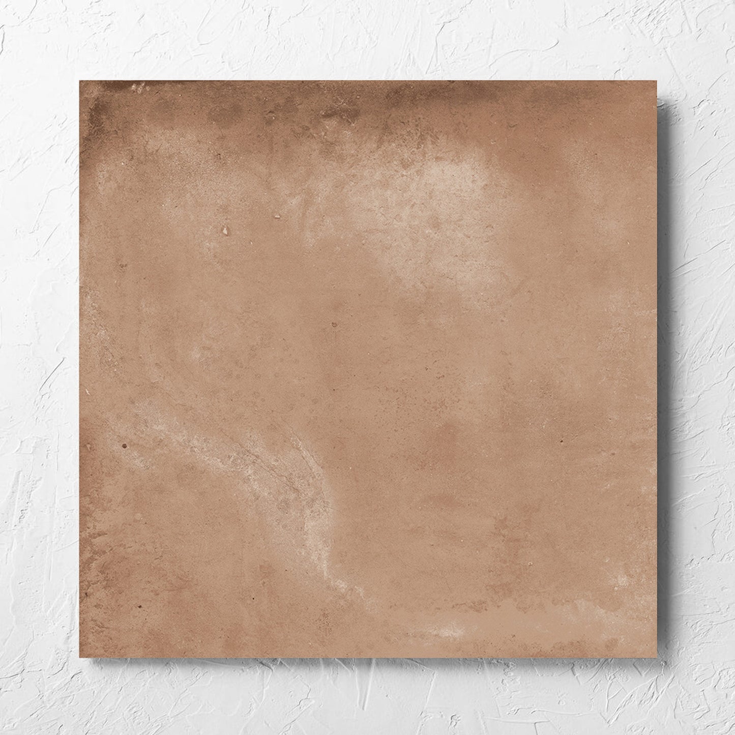 Clay Orvieto Light Terracotta 600x600mm tile laid flat on a white rendered wall, showing the matt surface