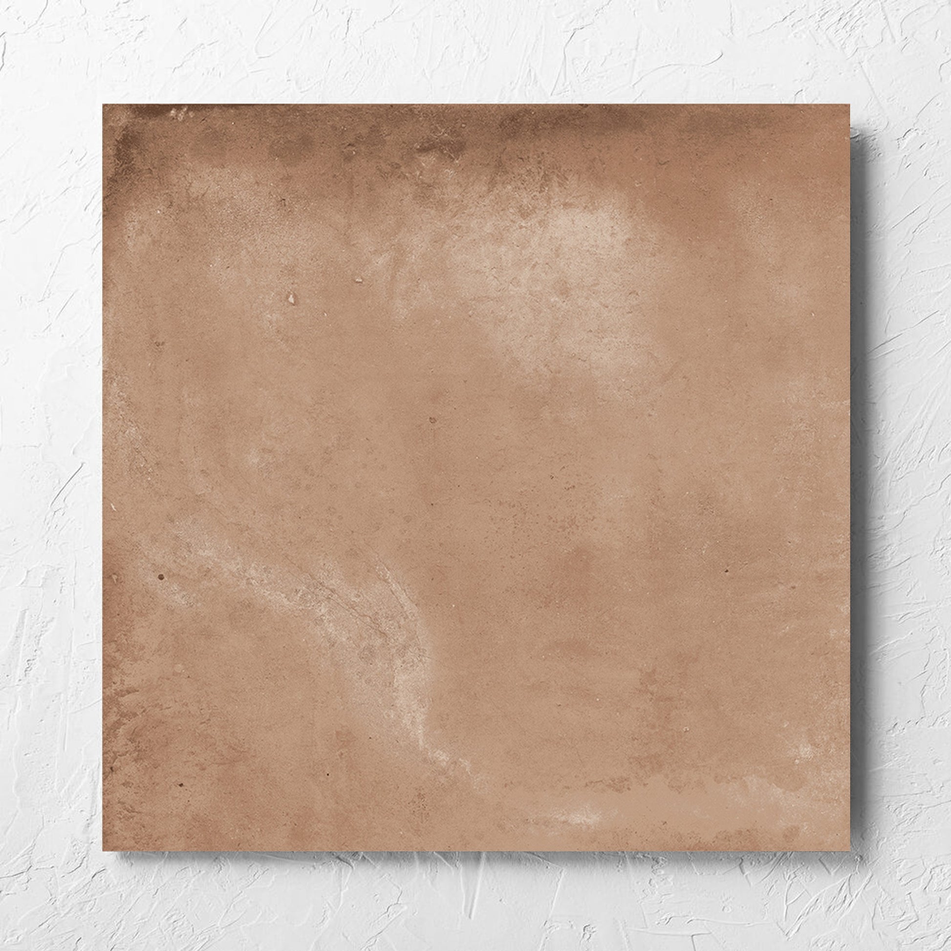 Clay Orvieto Light Terracotta 600x600mm tile laid flat on a white rendered wall, showing the matt surface