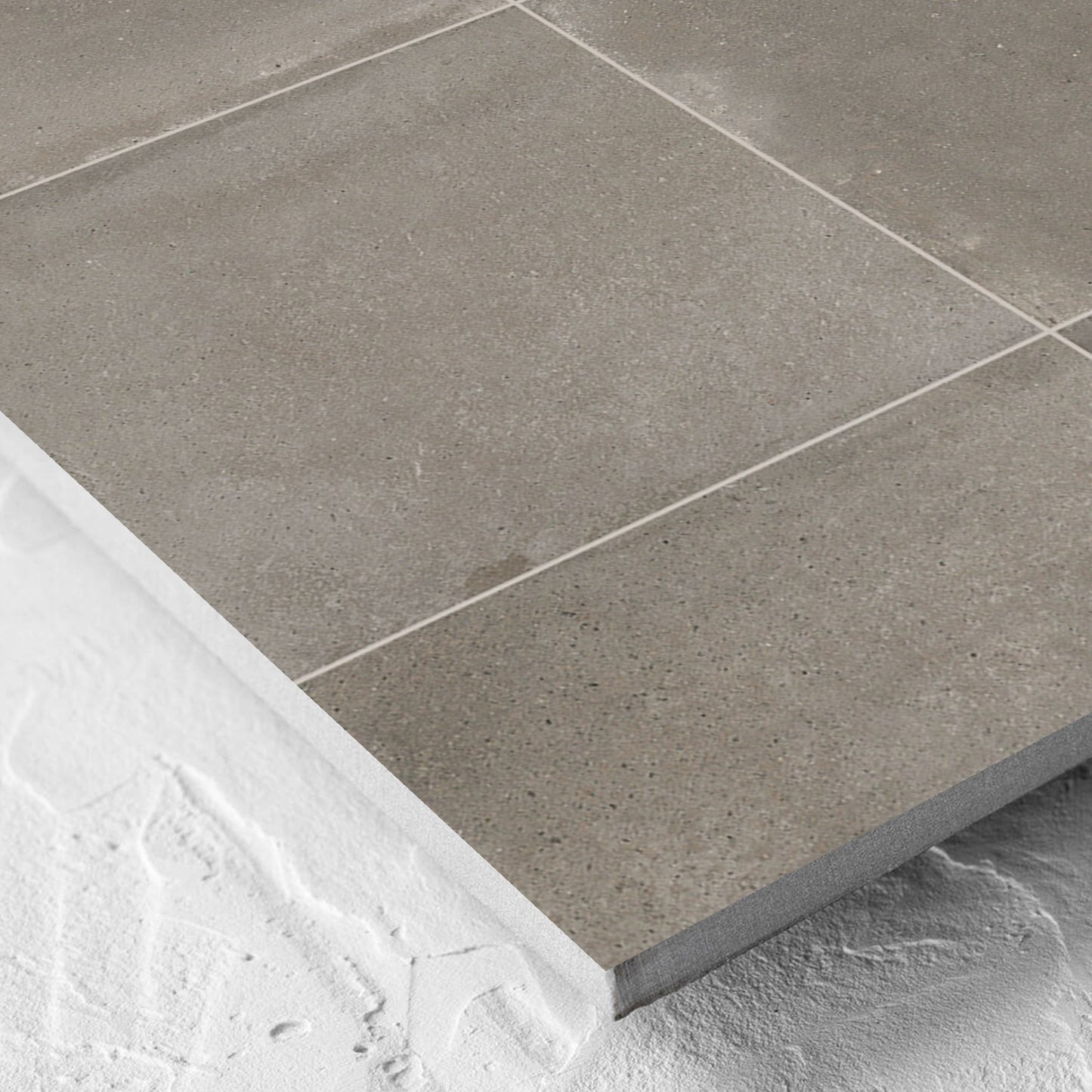 Corner close-up of the Cotto Concrete Matt 600x600mm tile showing the matt surface and the edge profile
