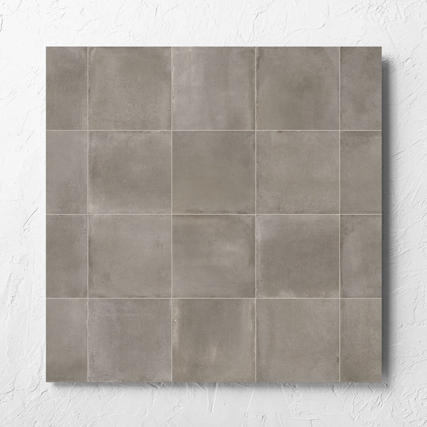 Cotto Concrete Matt 600x600mm tile laid flat on a white rendered wall, showing the matt surface