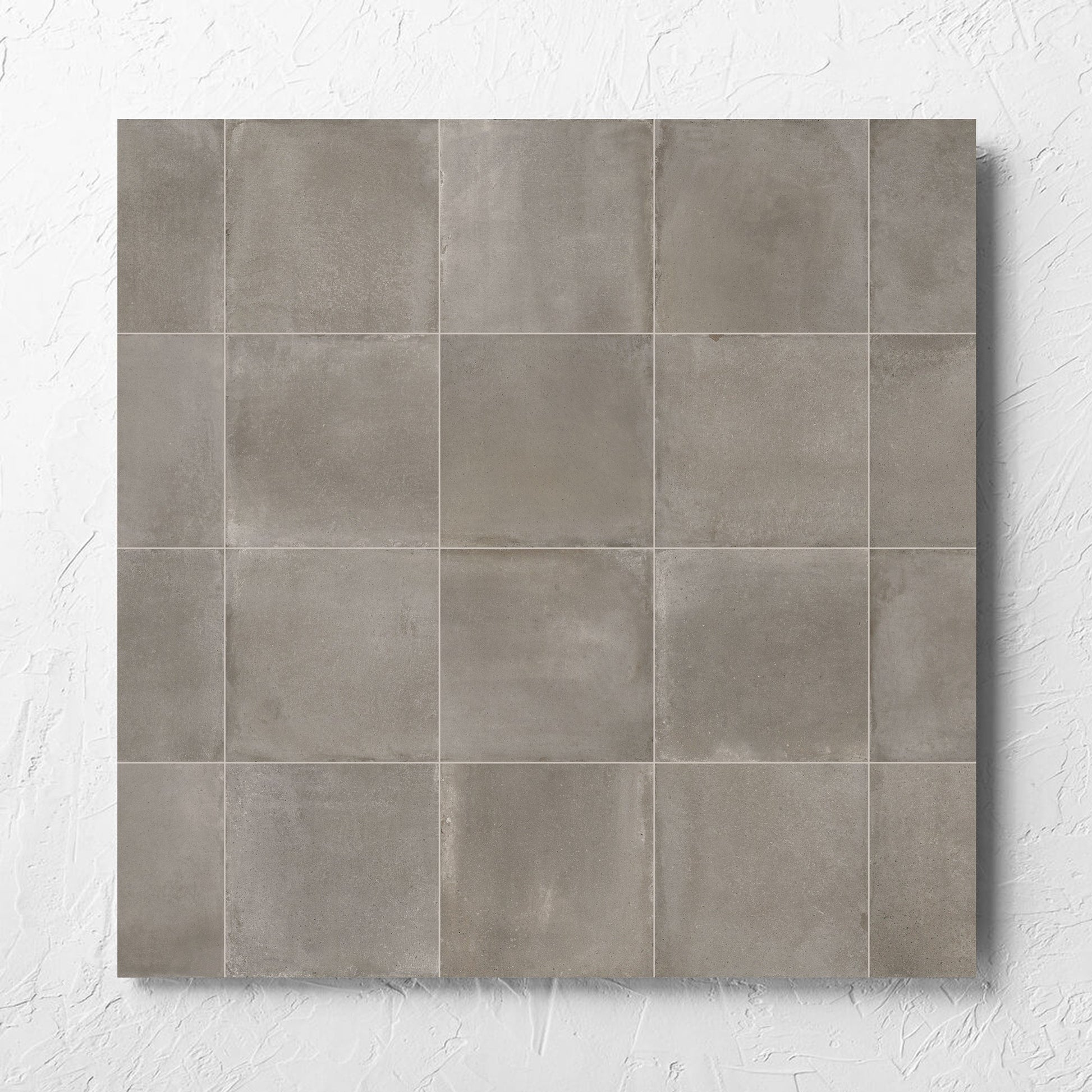 Cotto Concrete Matt 600x600mm tile laid flat on a white rendered wall, showing the matt surface