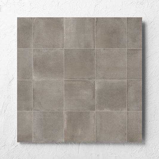 Cotto Concrete Matt 600x600mm tile laid flat on a white rendered wall, showing the matt surface