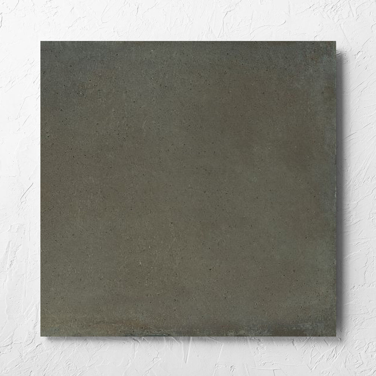 Cotto Khaki Matt 600x600mm tile laid flat on a white rendered wall, showing the matt surface
