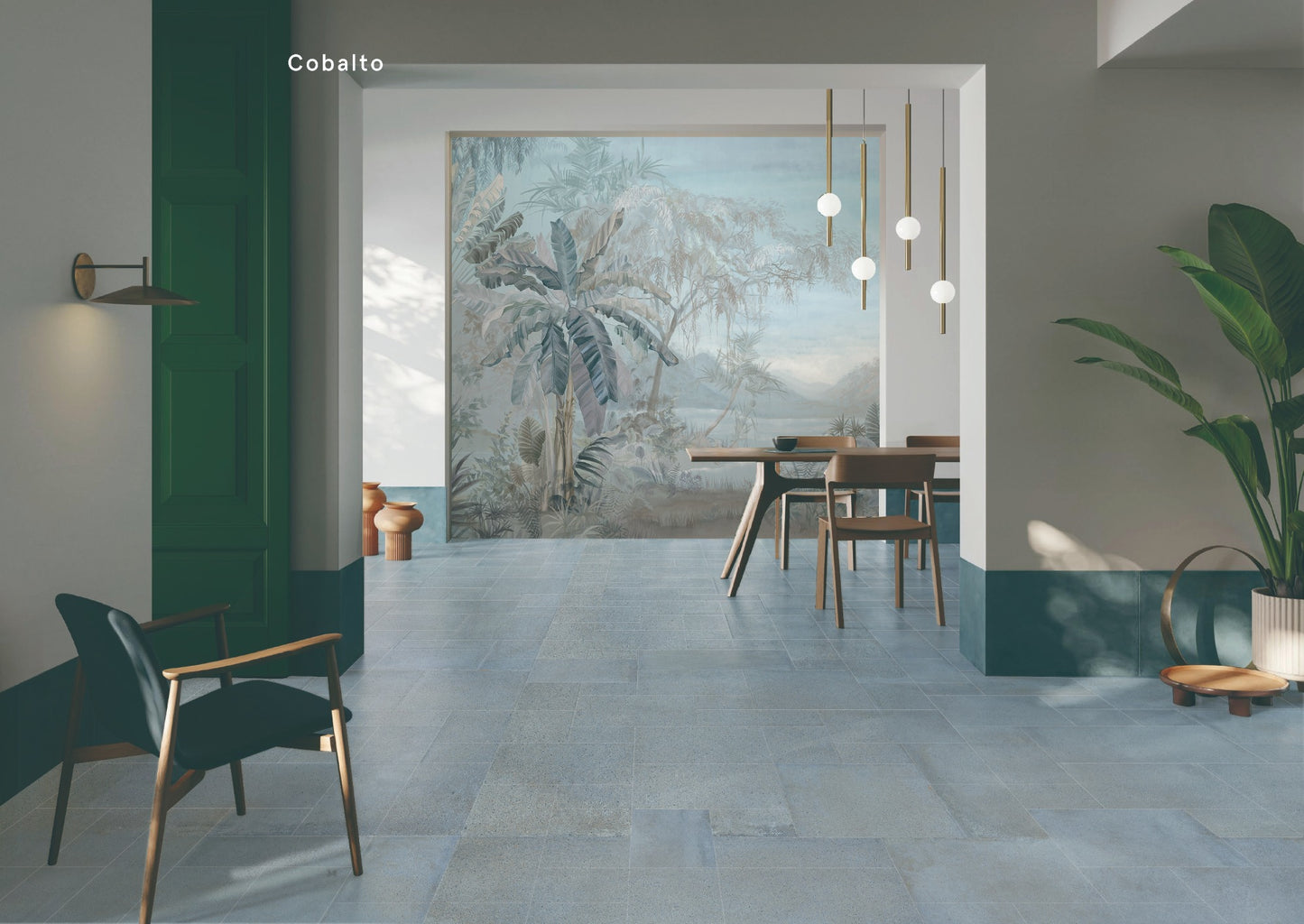 Cotto Sky Matt 600x600mm blue-grey stone-look floor tiles installed in a contemporary dining room with pendant lights and tropical mural wallpaper.