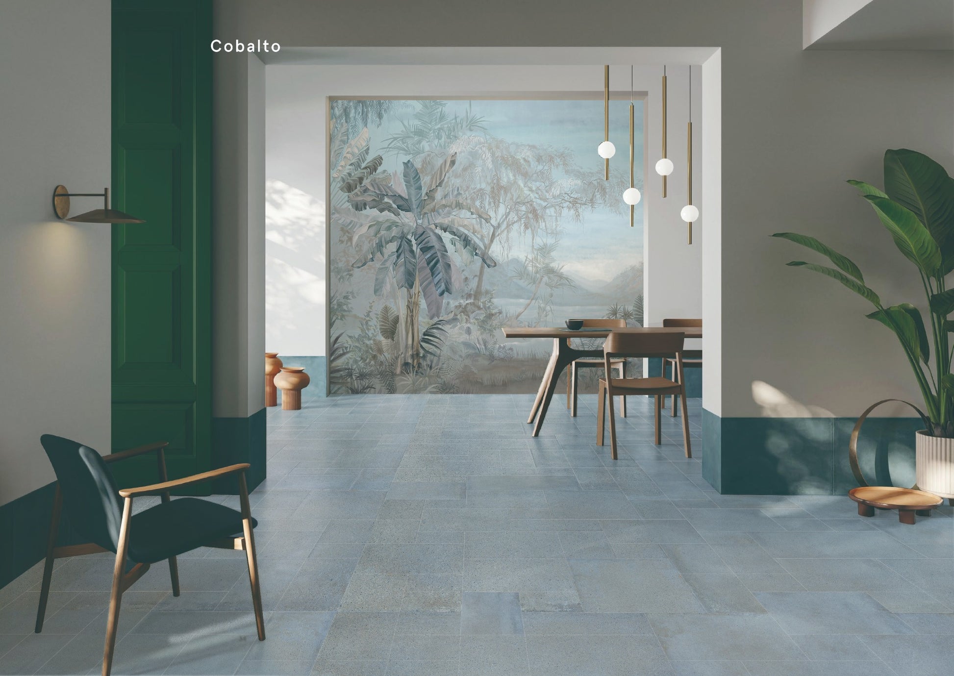 Cotto Sky Matt 600x600mm blue-grey stone-look floor tiles installed in a contemporary dining room with pendant lights and tropical mural wallpaper.