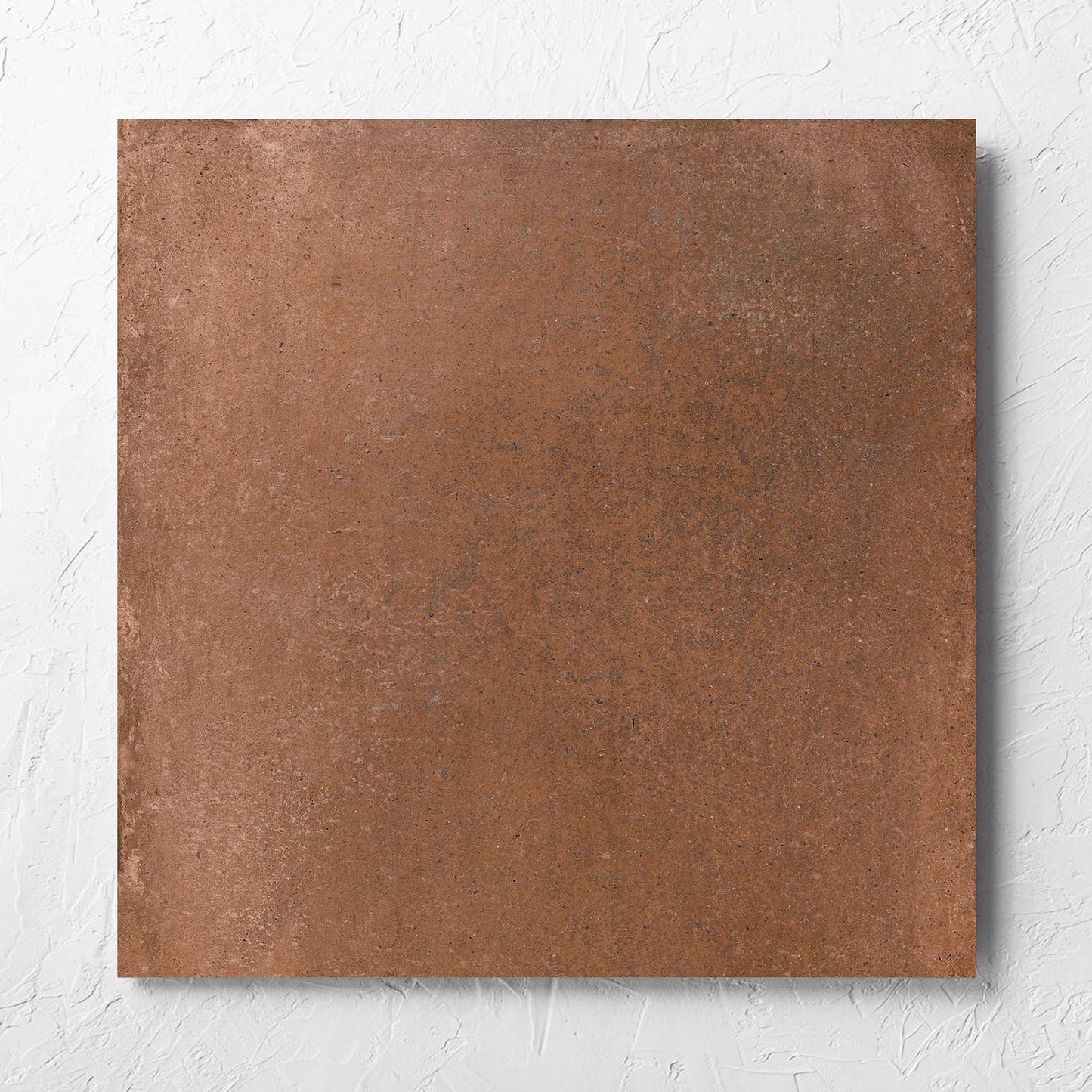 Cotto Terra Matt 600x600mm tile laid flat on a white rendered wall, showing the matt surface