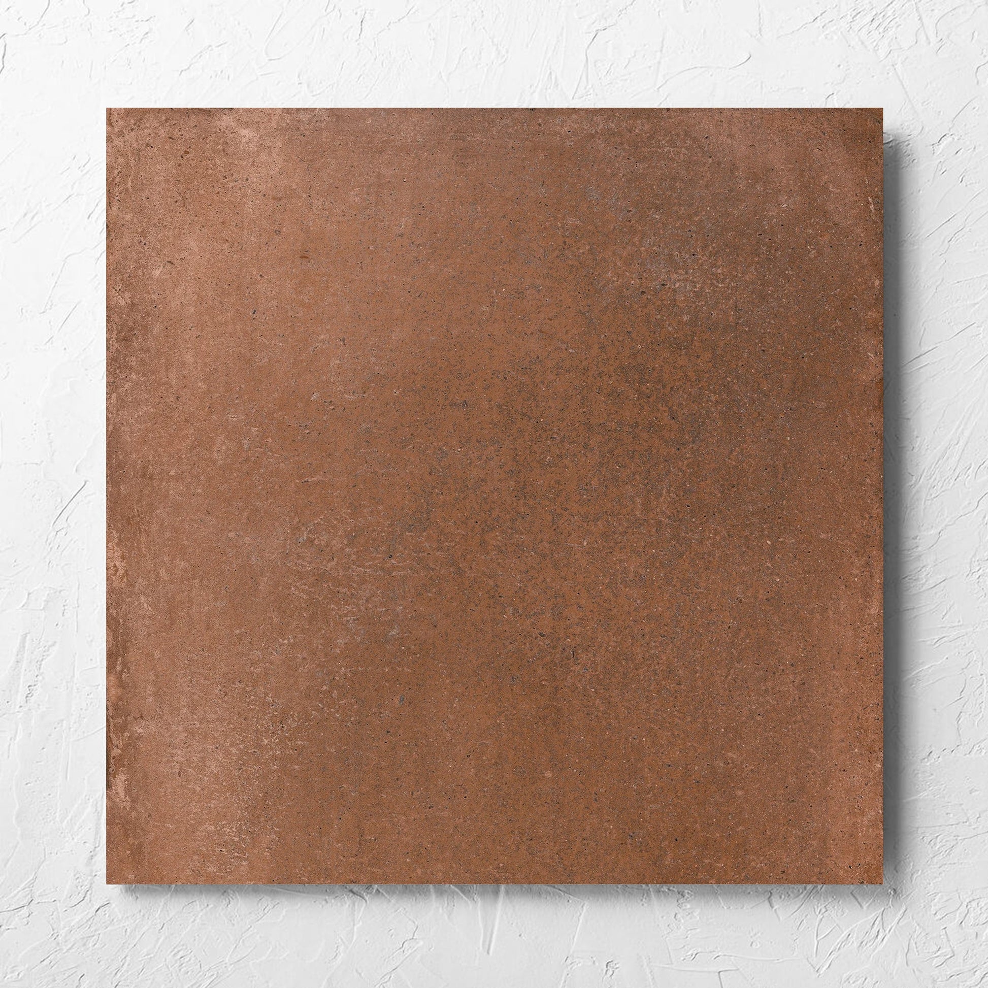 Cotto Terra Matt 600x600mm tile laid flat on a white rendered wall, showing the matt surface