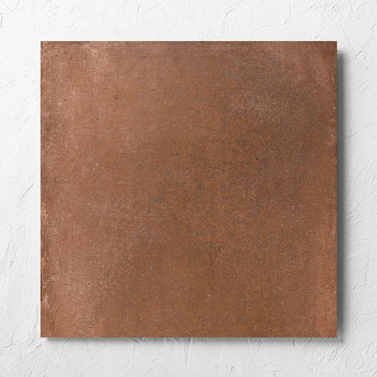 Cotto Terra Matt 600x600mm tile laid flat on a white rendered wall, showing the matt surface