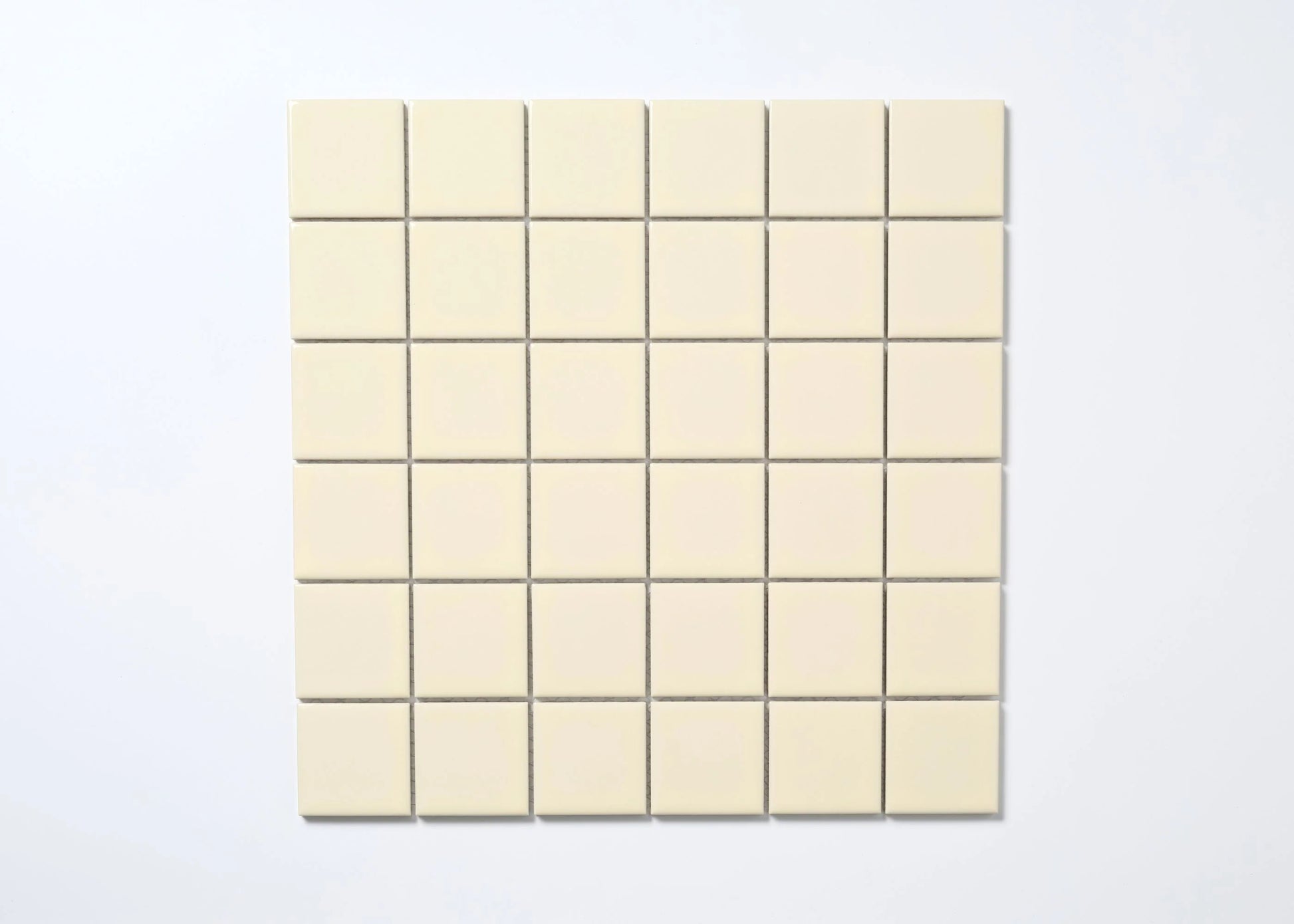 A flat lay pack shot of Cream Gloss Porcelain Glazed 48x48mm Square tiles arranged in a 6x6 mosaic sheet with fine grey grout lines.