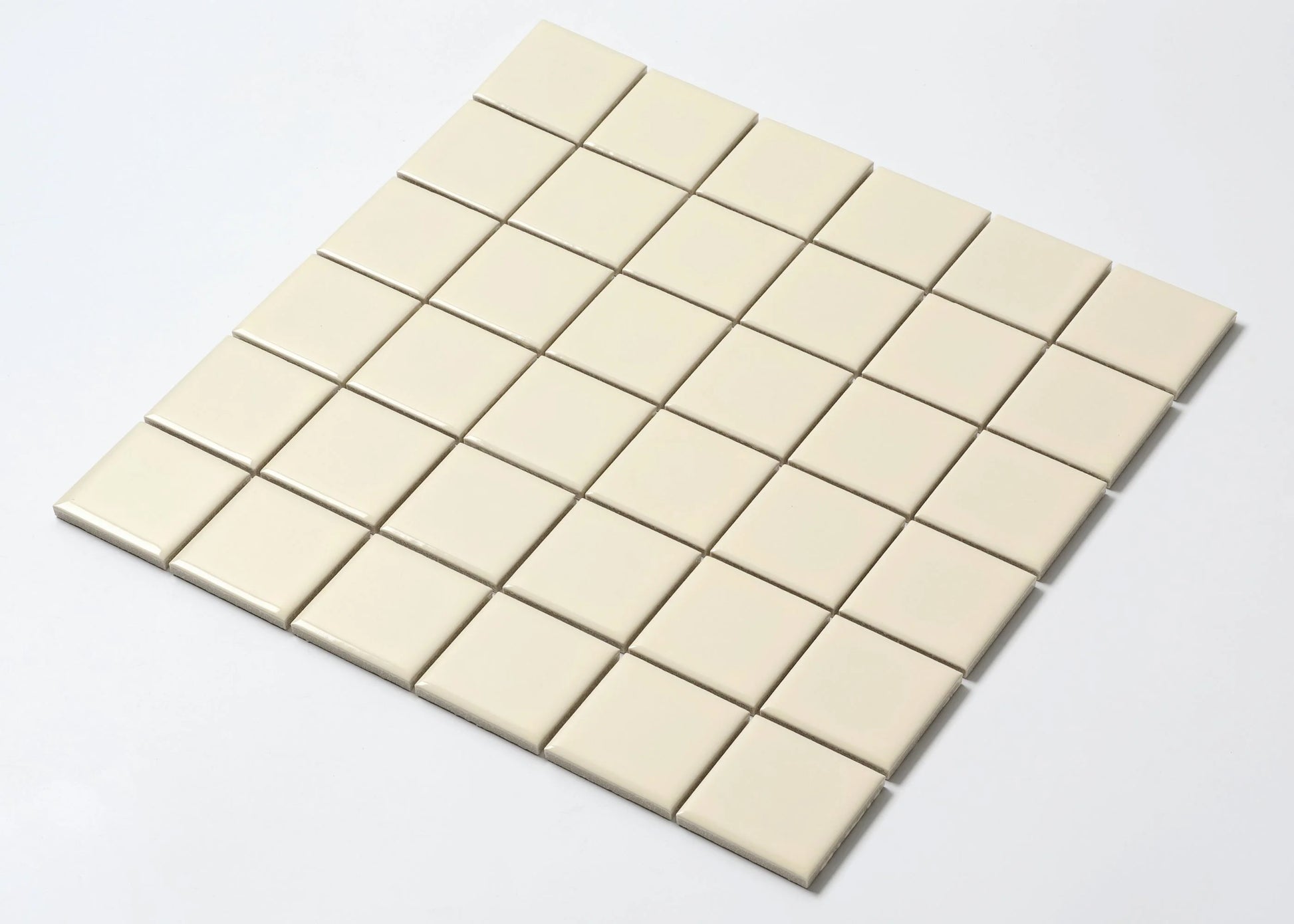 Pack shot of Cream Gloss Porcelain Glazed 48x48mm Square mosaic tile sheet showing uniform cream-coloured glazed square tiles arranged in a grid on a white background.