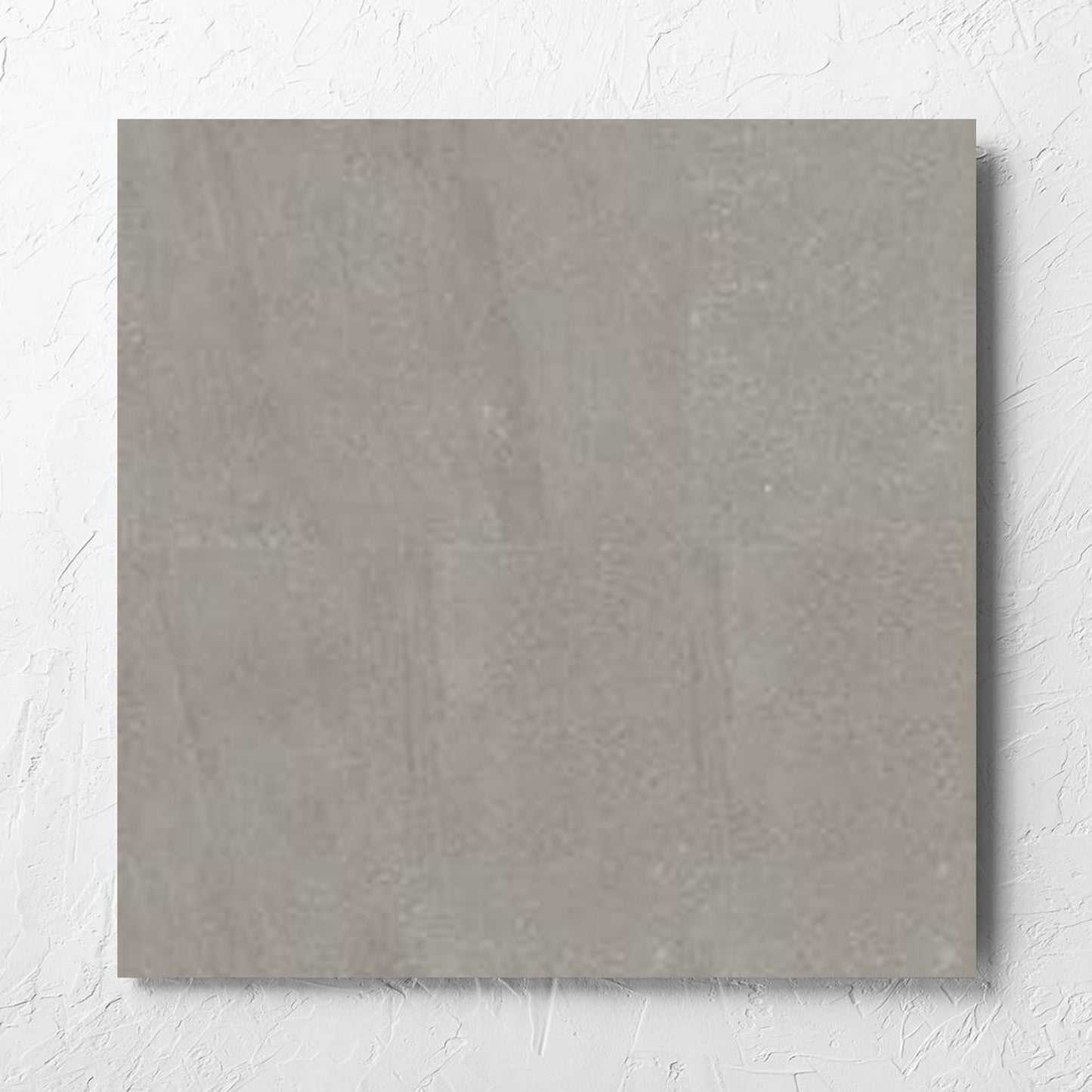 Crystal Quartz Greige Matt Rectified 600x600mm tile laid flat on a white rendered wall, showing the tile surface