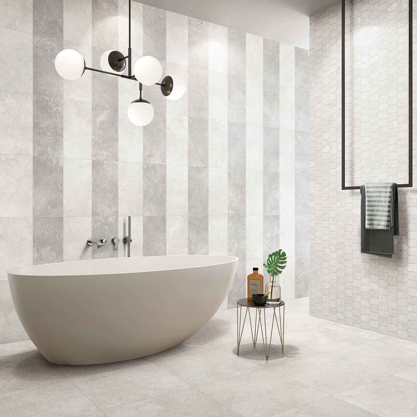 Dino Bianco Rectified InOut 600x600mm light grey tiles installed as a striped feature wall behind a freestanding white bath with globe pendant lighting.