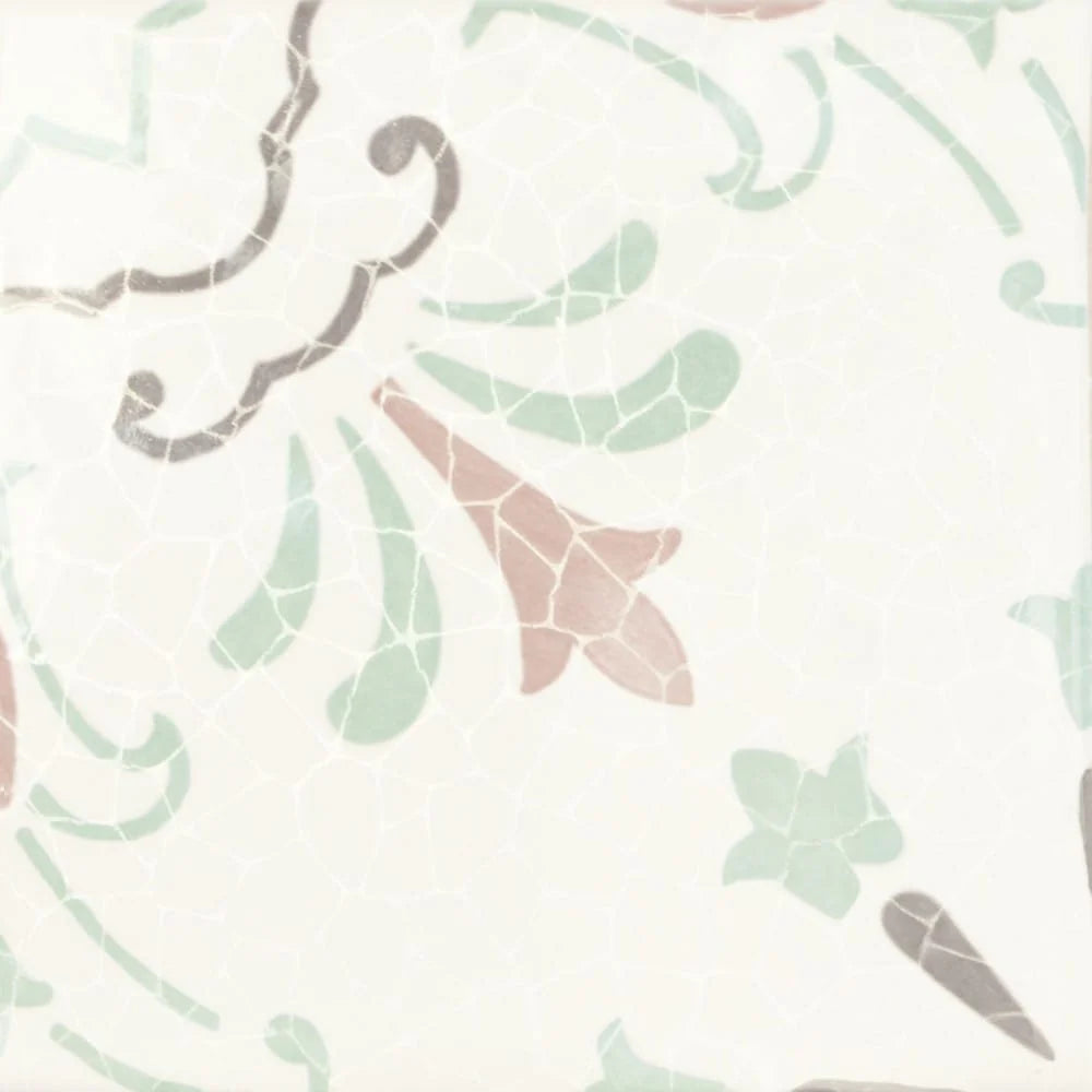 Close-up of Dune Giuliana 147x147mm ceramic tile featuring a delicate crackle-glazed white surface with sage green, dusty rose, and grey botanical motifs.