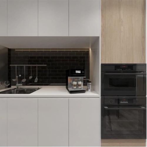 Edge Black Wave Gloss 68x280mm tiles installed as a dark kitchen splashback behind a coffee machine with white cabinetry and built-in oven.
