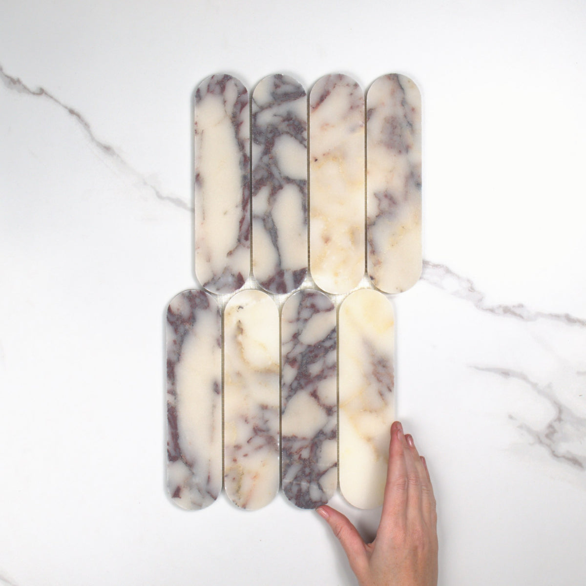 Elementa Calacatta Viola Cylinder Mosaic 50x198mm top view, hand for scale