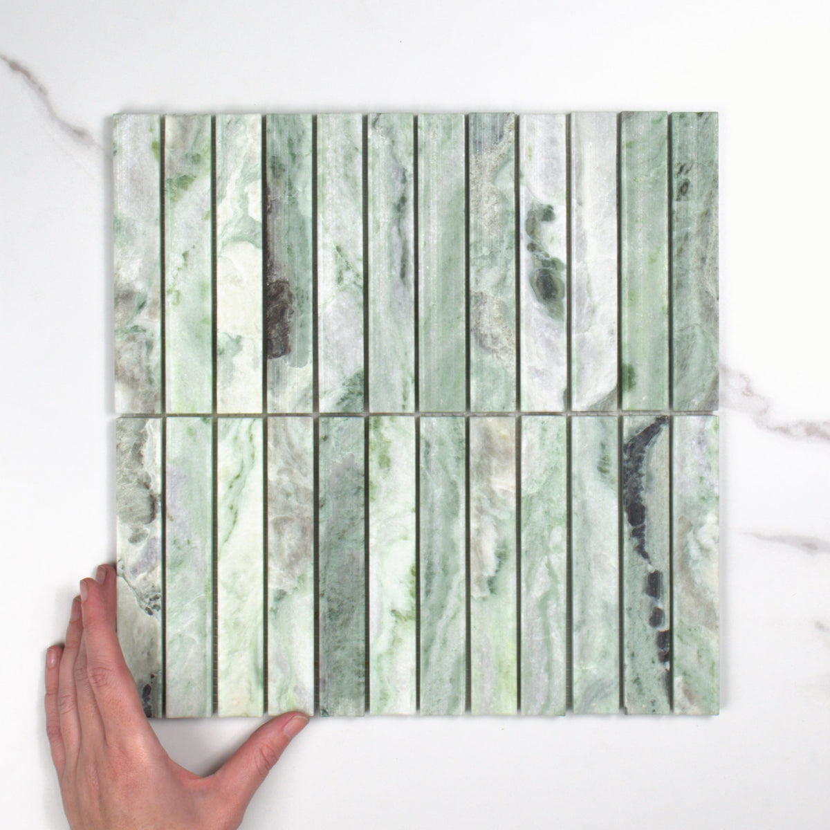 Elementa Cloud Emerald Concave Mosaic 23x148mm top view, hand for scale