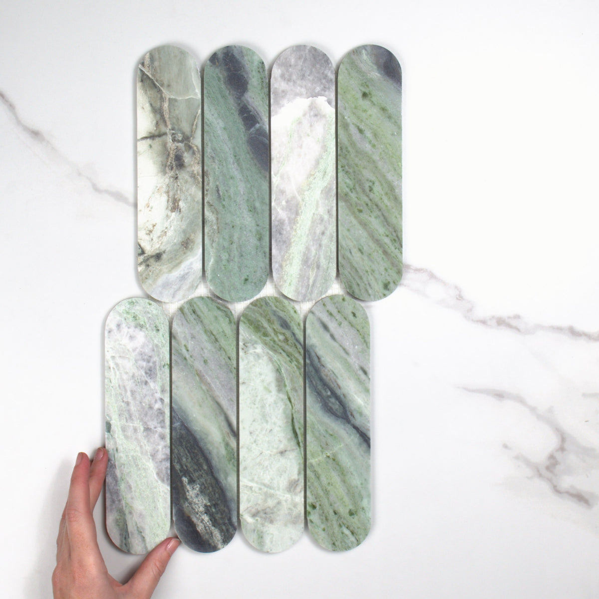 Elementa Cloud Emerald Cylinder Mosaic 50x198mm top view, hand for scale