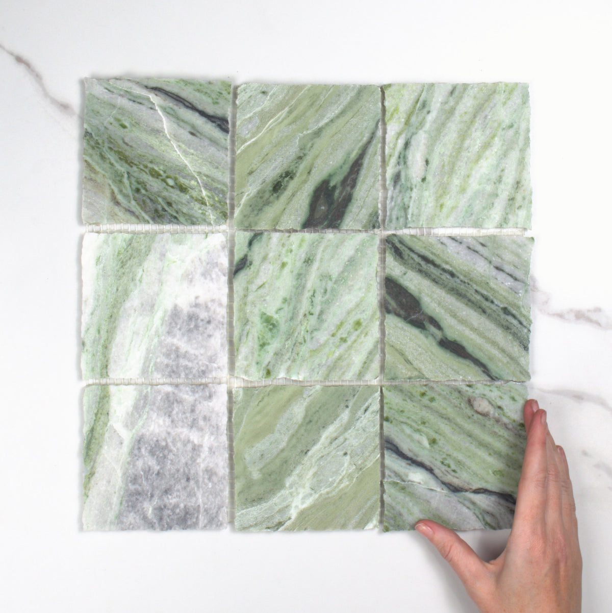 Elementa Cloud Emerald Mosaic 100x100mm top view, hand for scale
